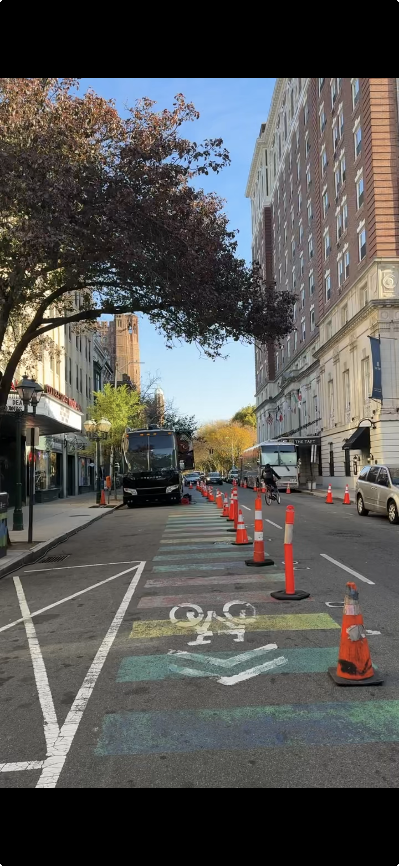 Tour buses outside a venue on a street.