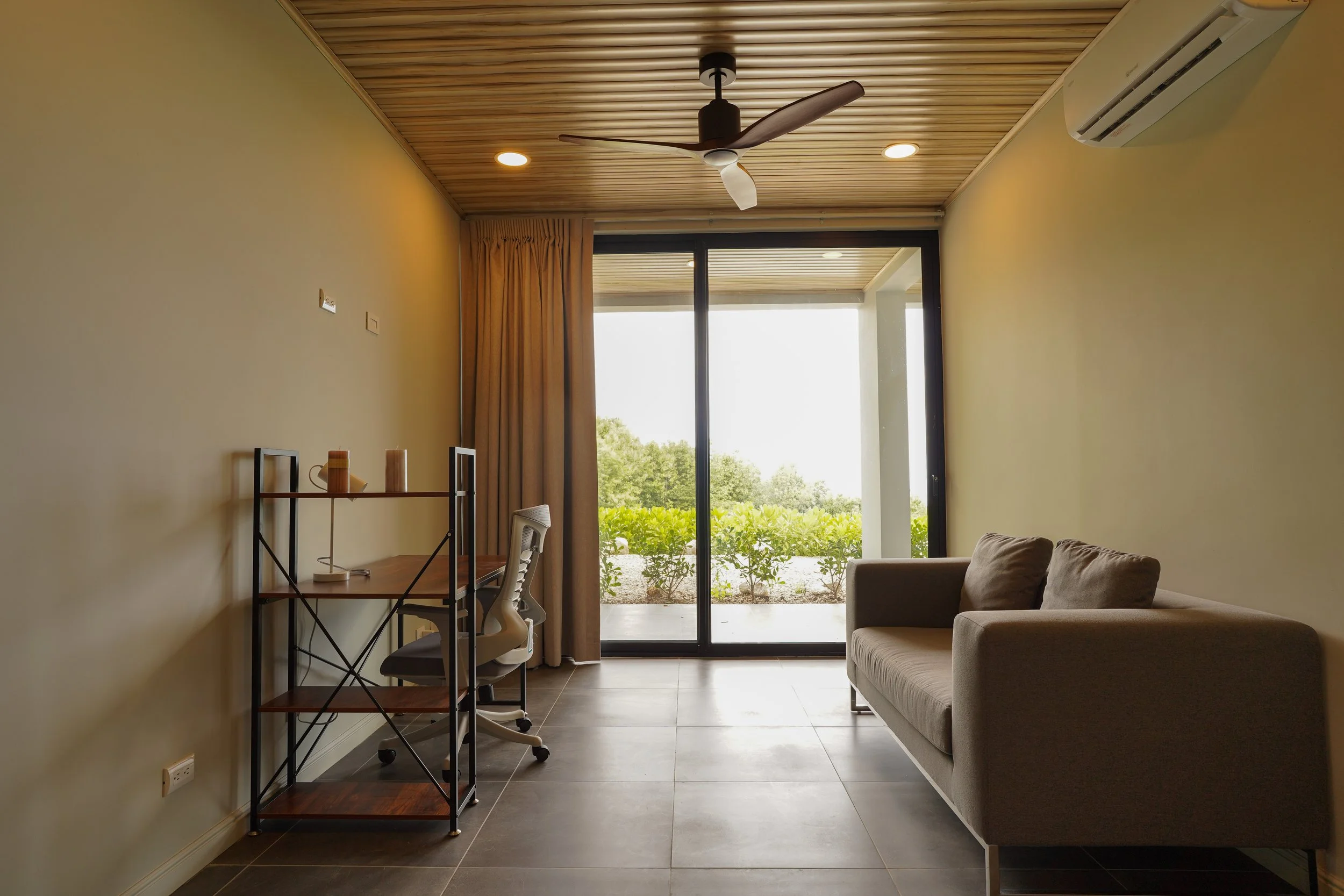 Bright living area with a dedicated ergonomic workspace and desk, ideal for remote work in Costa Rica.