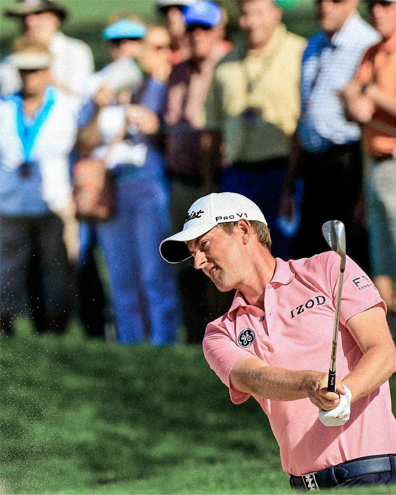 Golfer in pink shirt swinging club at a golf course, with spectators in the background.