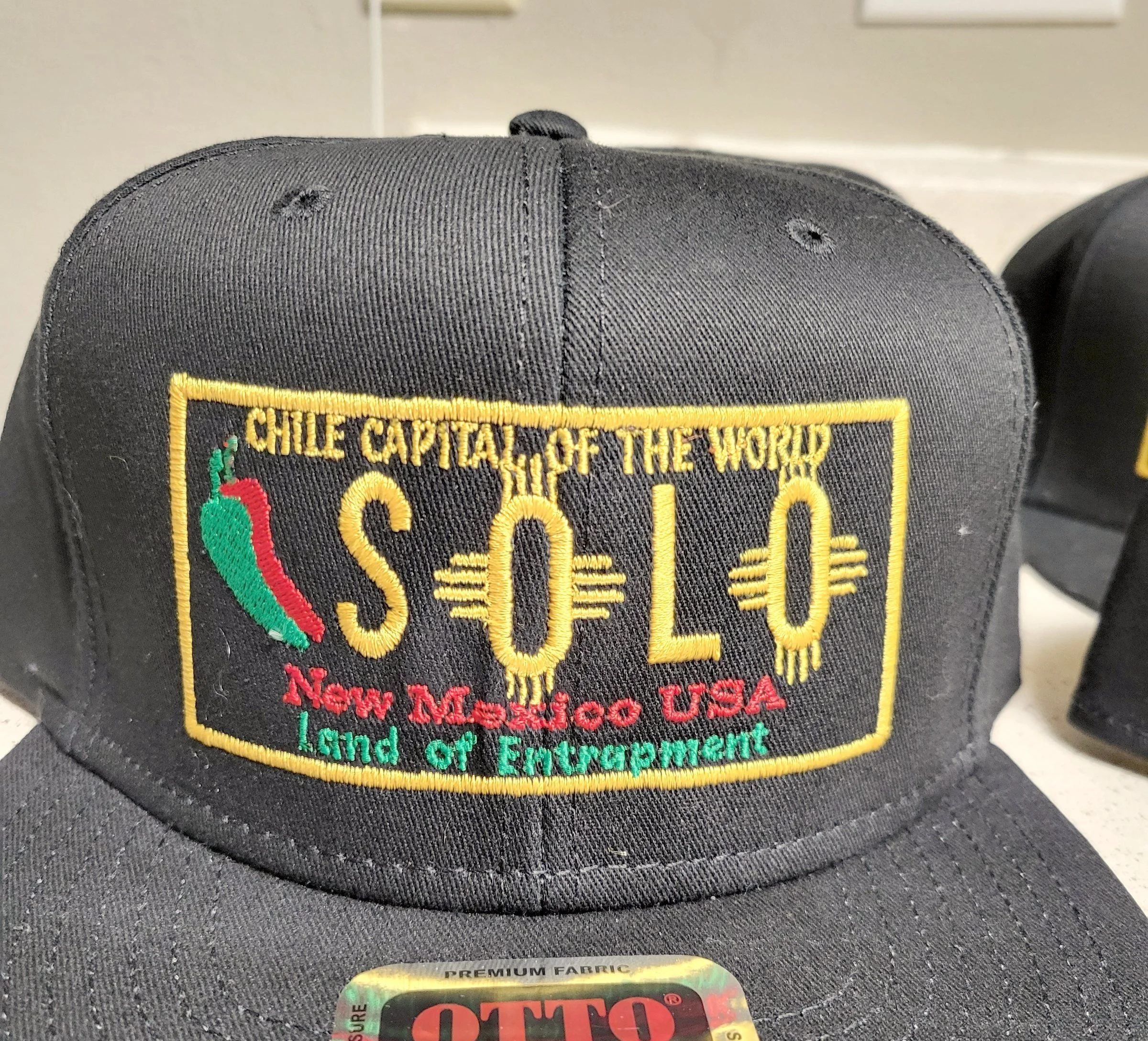 Black snapback with an embroidered Chile Capital of the World, New Mexico USA patch