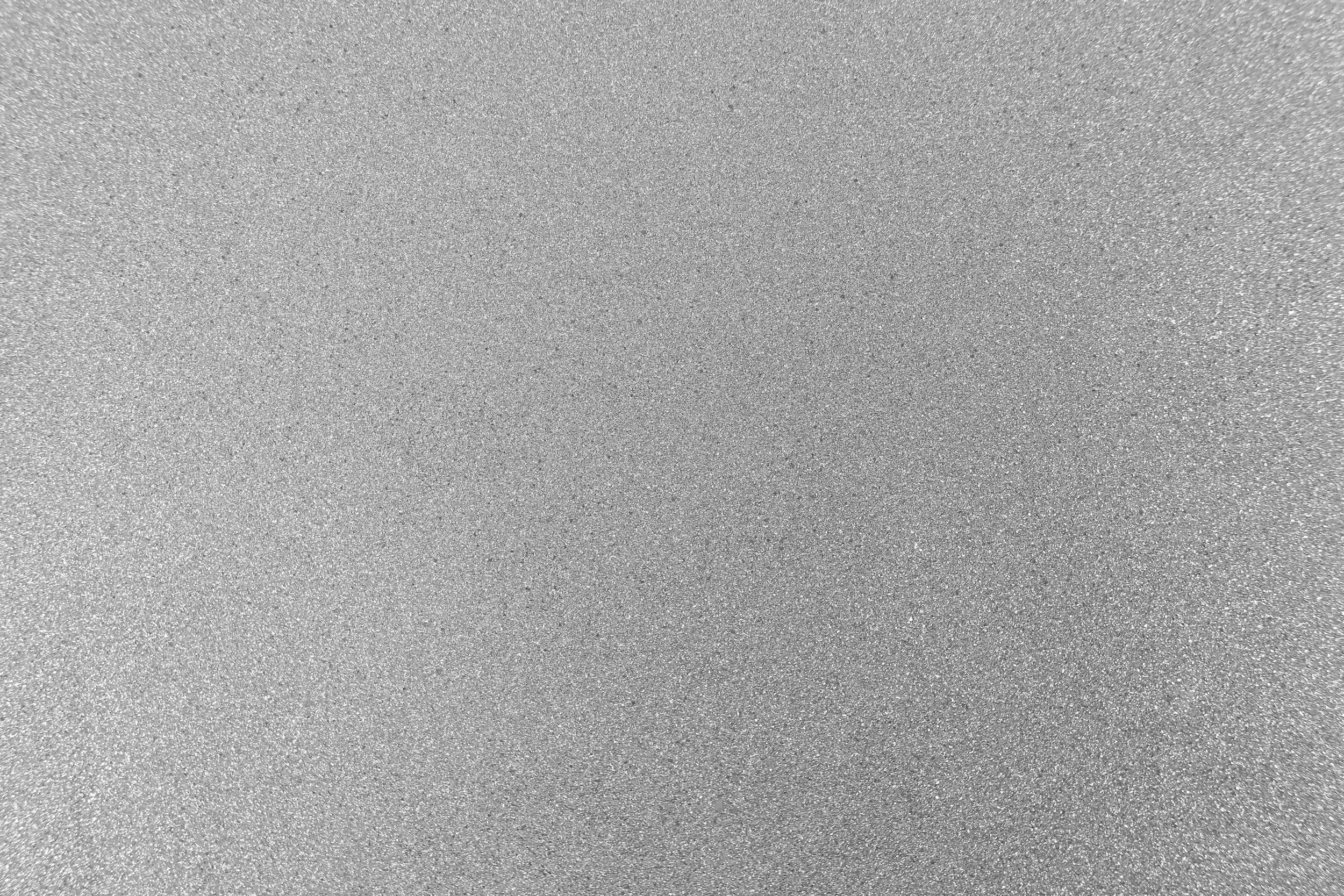 Gray, textured surface with a glittery appearance.