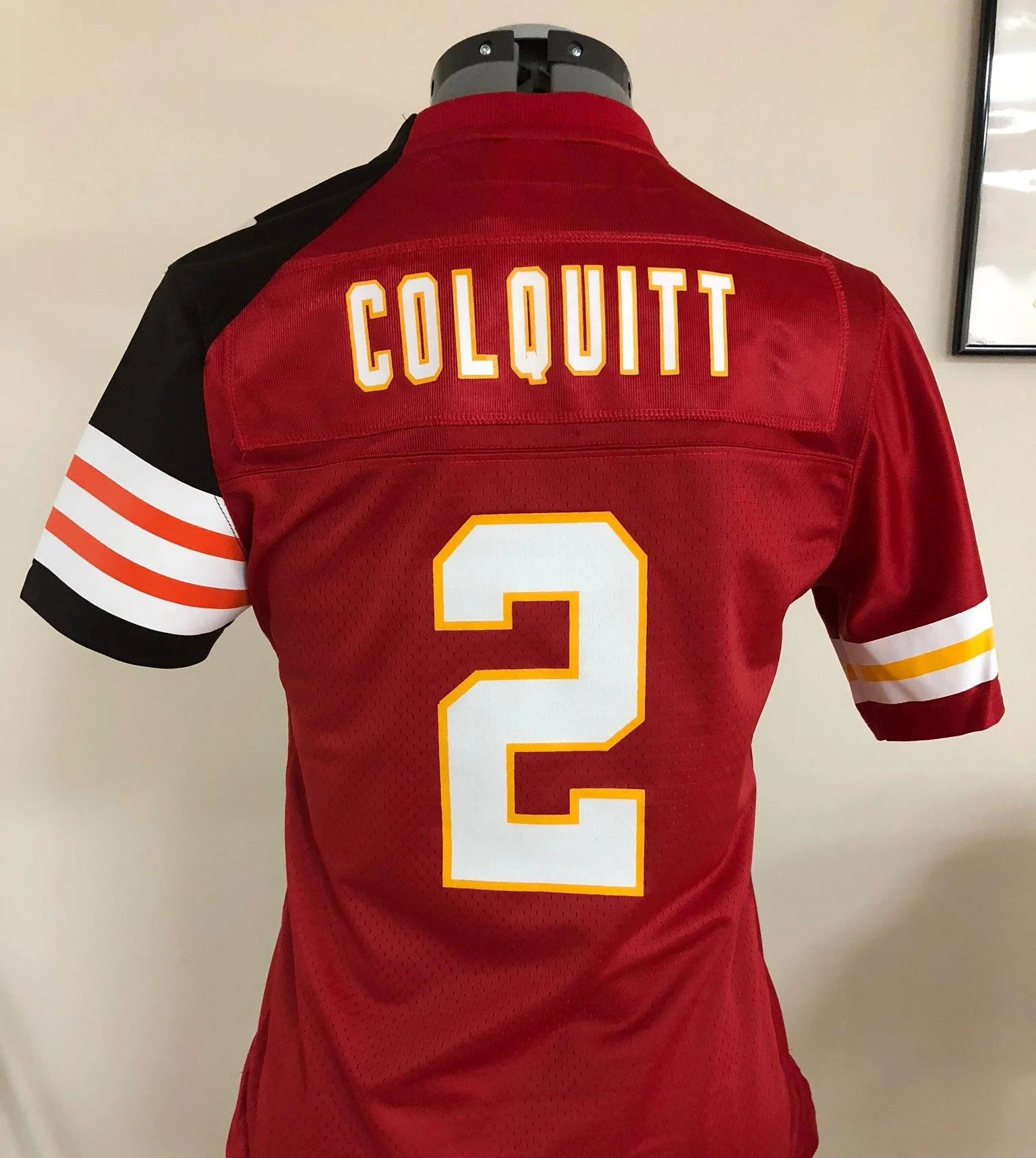 A Kansas City Chiefs and Cleveland Browns Split football jersey on a display mannequin with the name 'Colquitt' and the number 2 on the back.