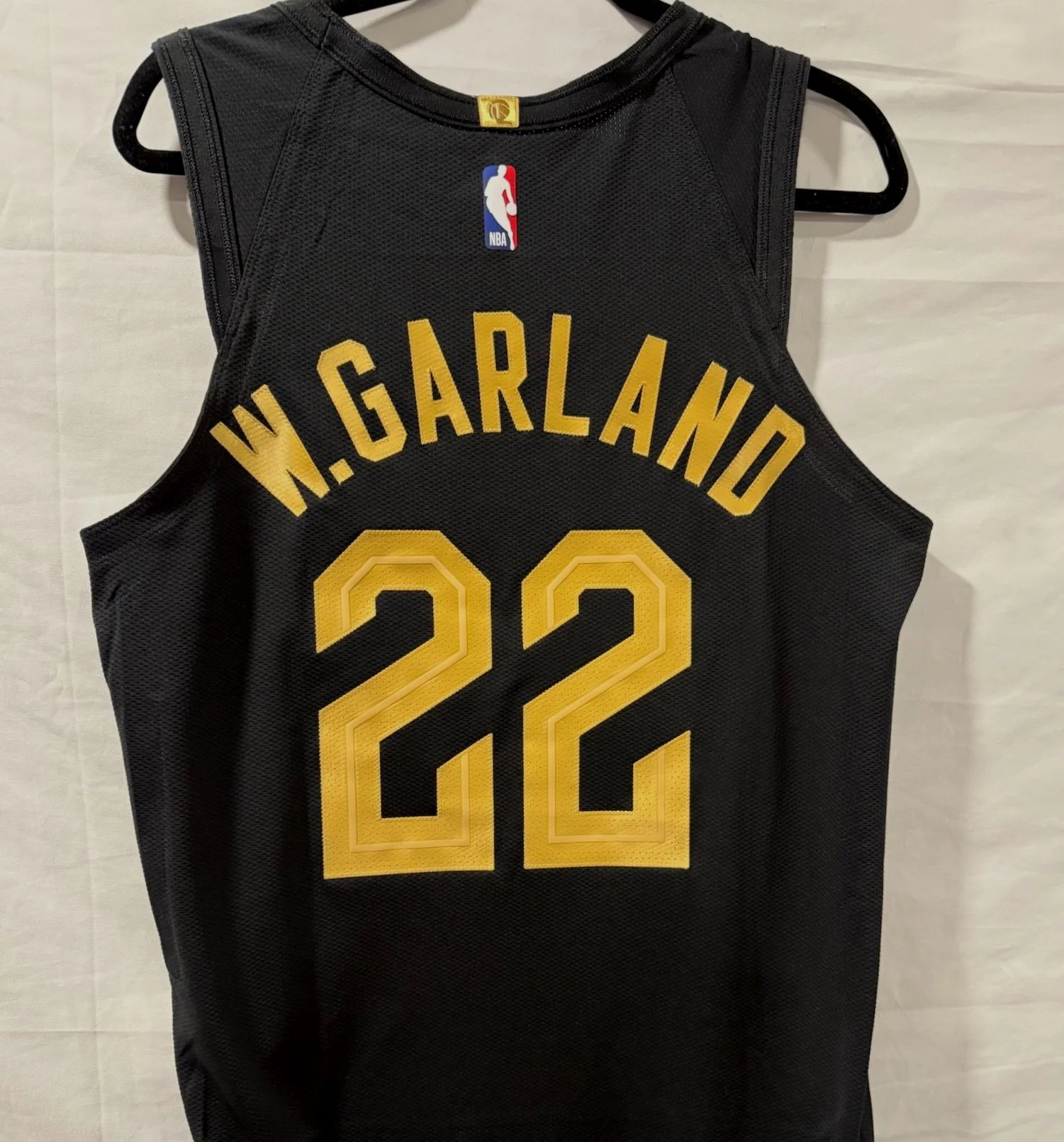 Black NBA basketball jersey with gold numbers and lettering, displaying the name 'W. Garlando' and the number '22'.