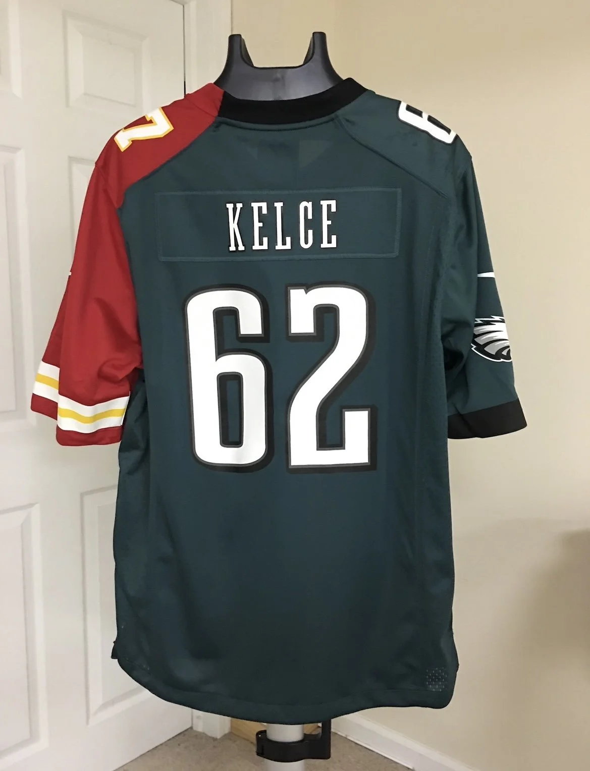 Philadelphia Eagles and Kansas City Chiefs Split football jersey with the name Kelce and the number 62 displayed on a mannequin.