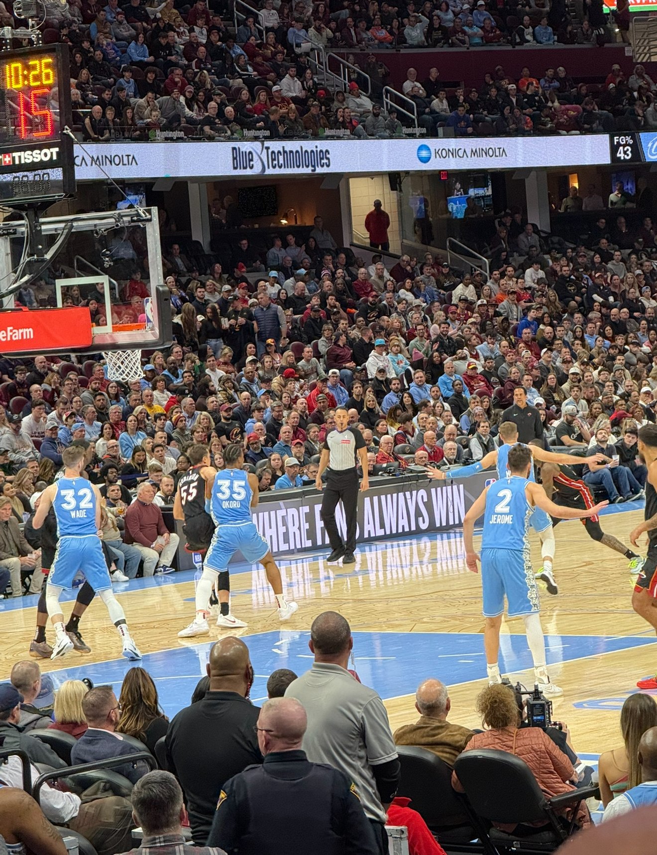 An NBA basketball game with players in blue jerseys on the court and spectators in the stands. The scoreboard shows 10:26 remaining in the game and 15 seconds on the shot clock.