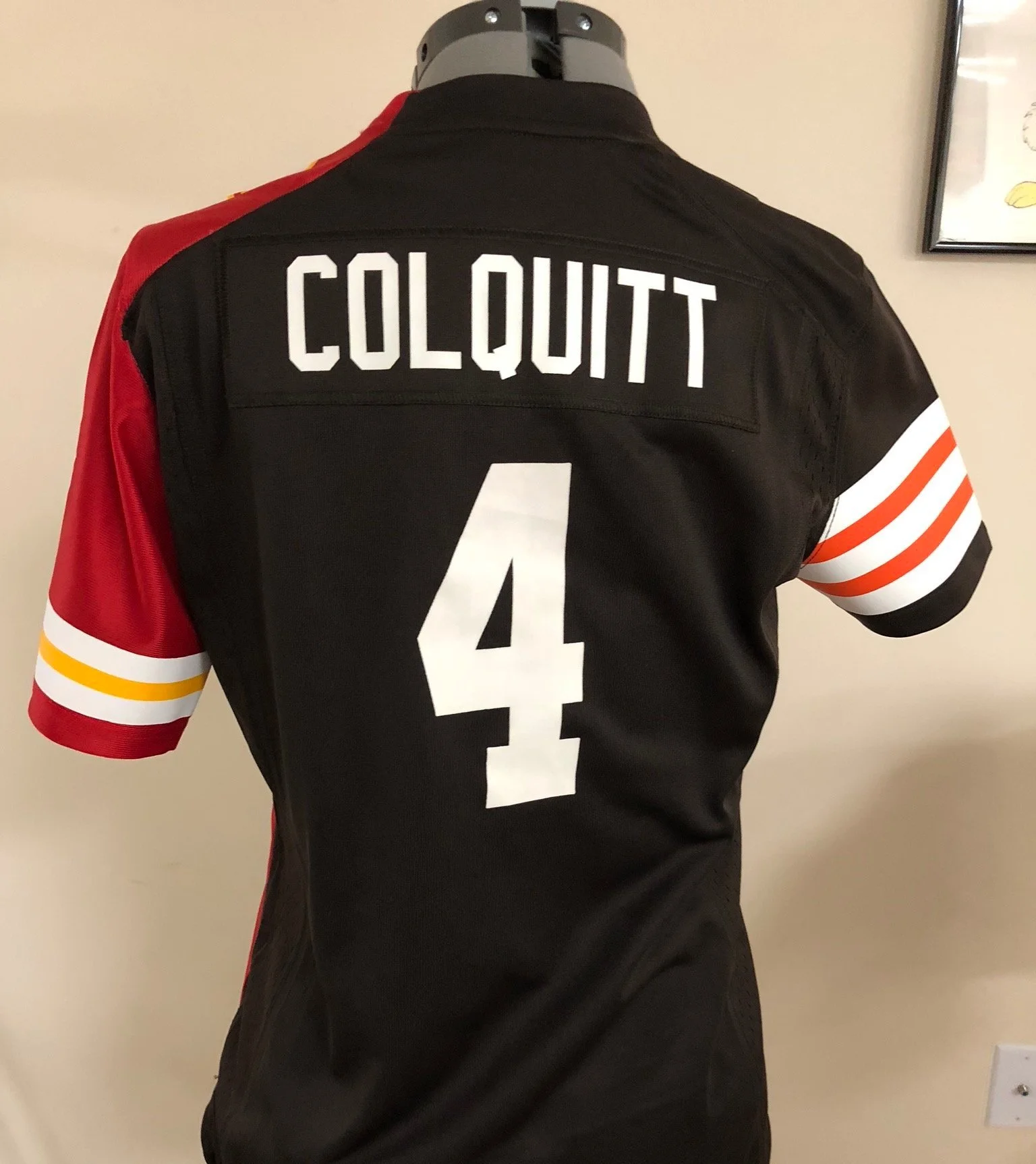 The back of a Kansas City Chiefs and Cleveland Browns Split football jersey on a display mannequin with the name 'Colquitt' and the number 4 on the back.