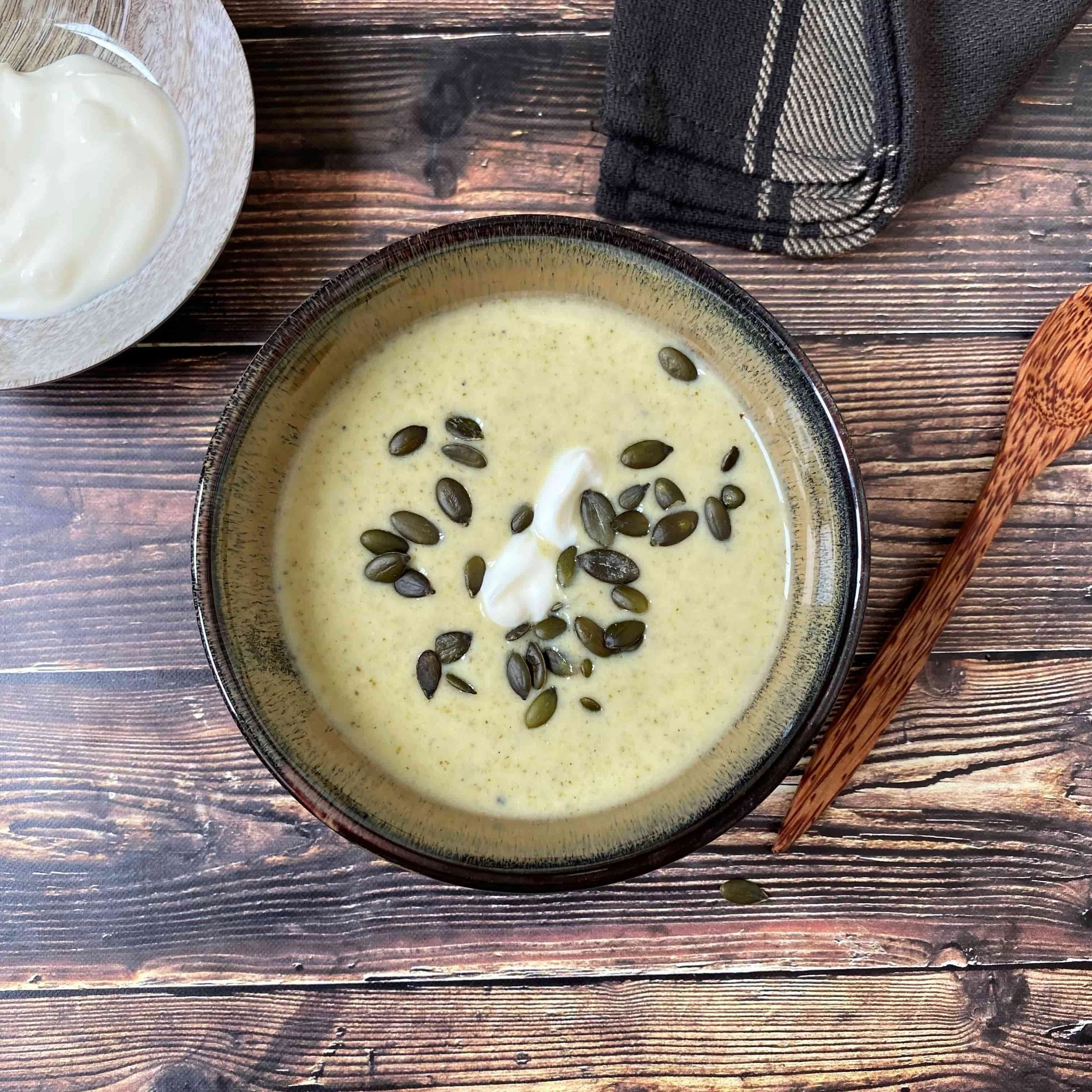 Healthy creamy broccoli and spinach soup with ginger, basil and coconut yoghurt
