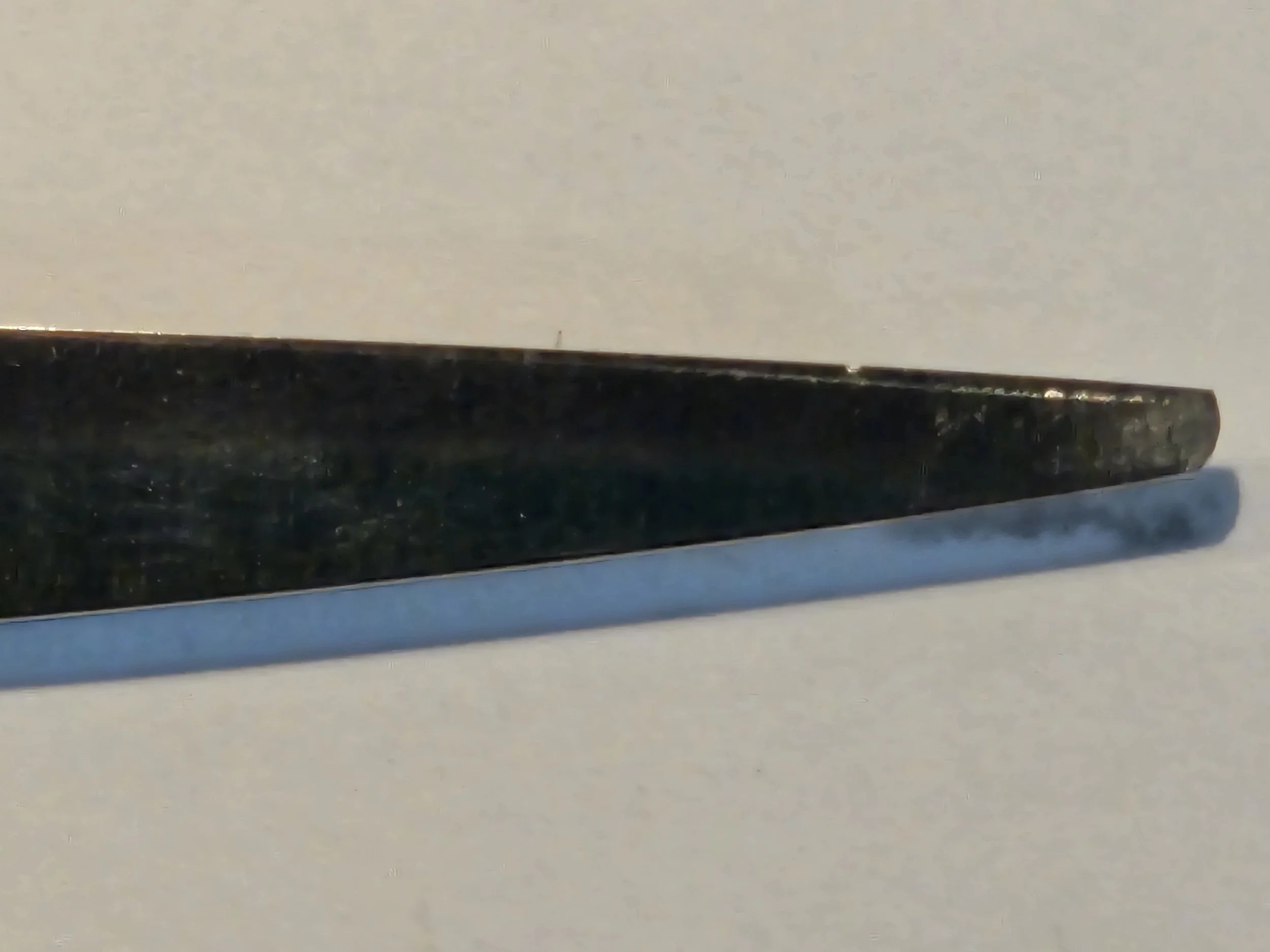 Close-up of a blade of professional hair cutting scissors shears.