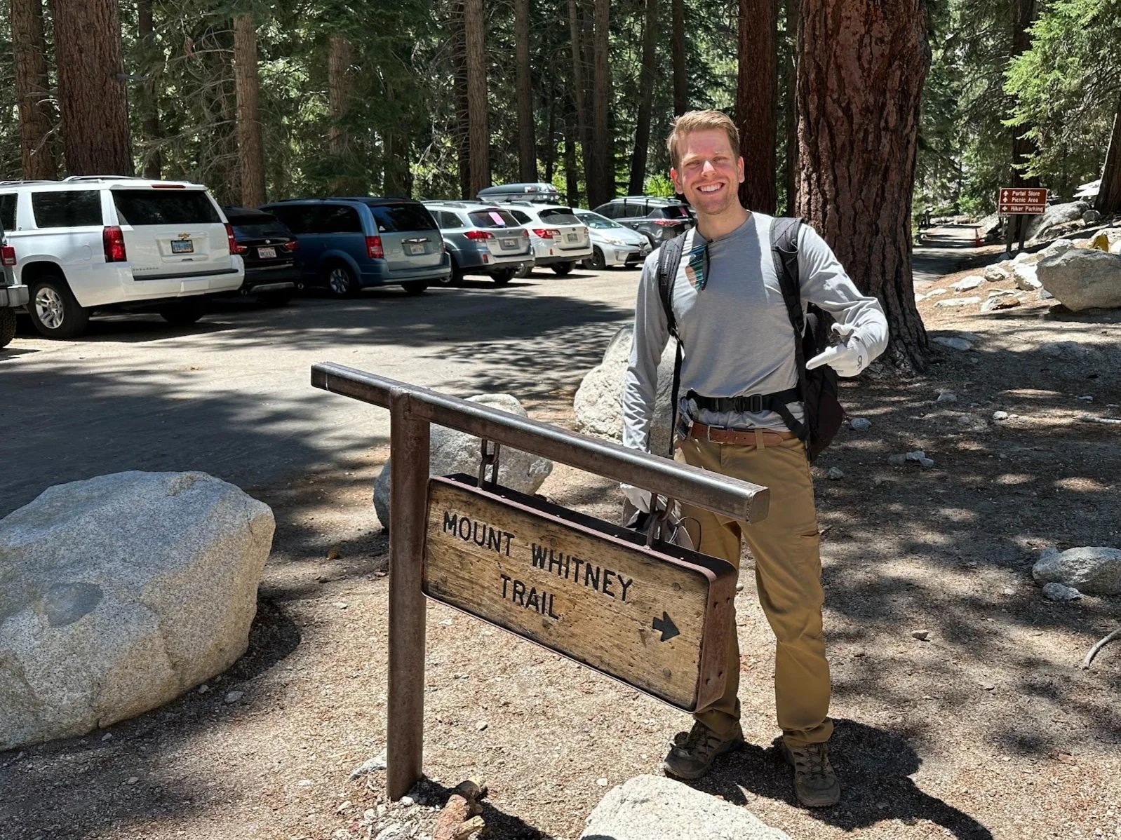 Photo of David pointing to "Mount Whitney Trail" sign