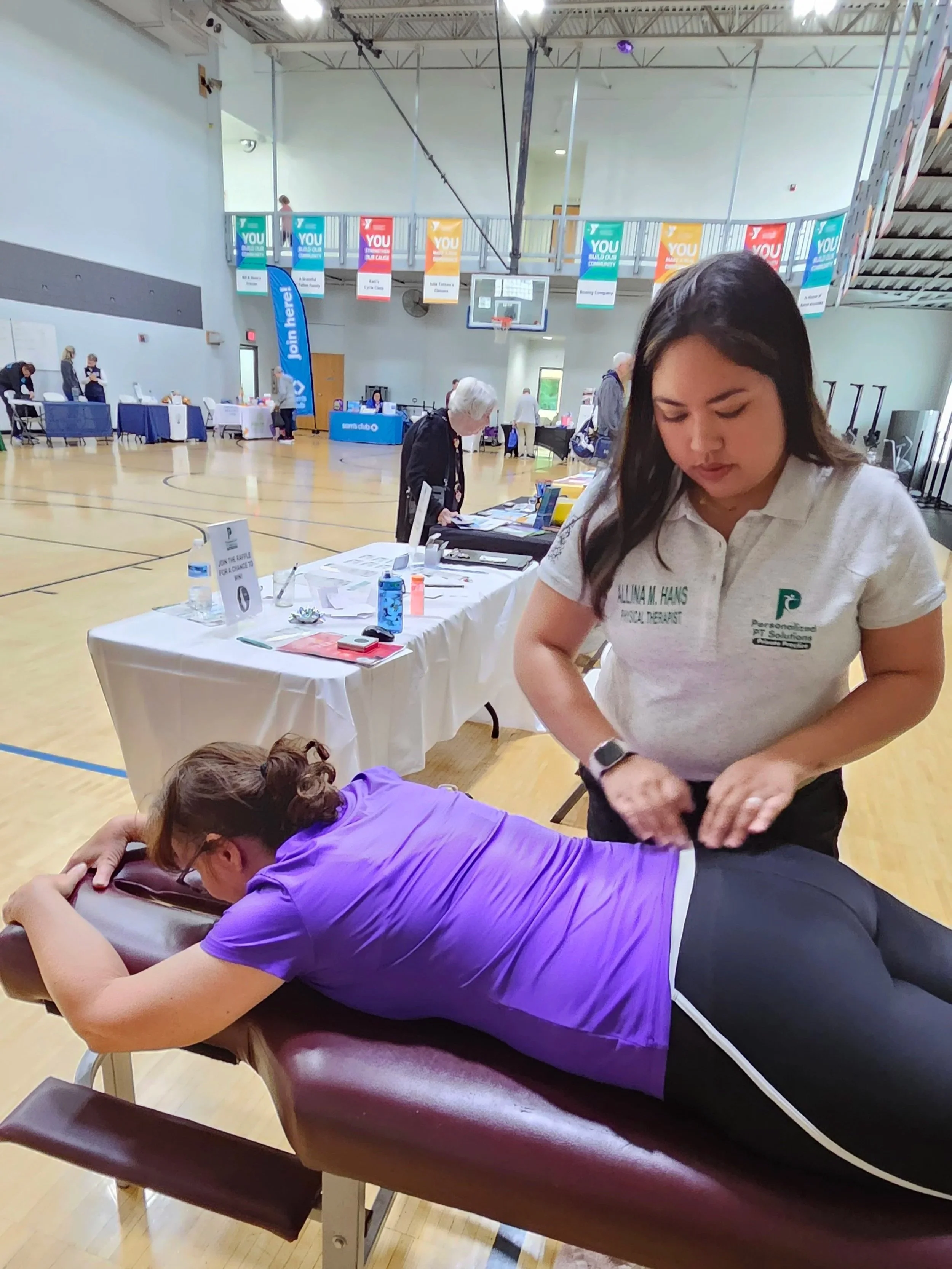 Allina "Nica" Hans performs an assessment for Personalized PT Solutions booth at O'Fallon IL YMCA Senior Health Fair