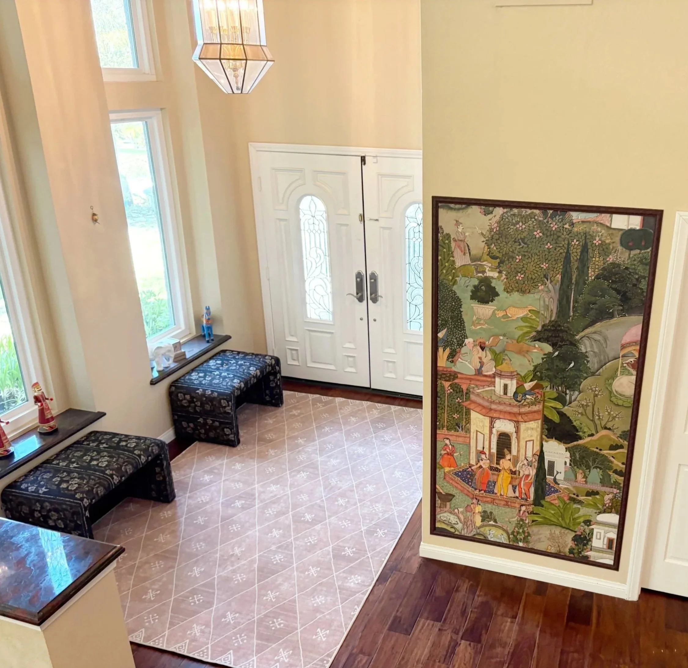 Foyer entry renovation with south asian fusion style. Designed by haveli designs in colorado. Wall murals with Gardens of jaipur wallpaper. Arhaus seating and ruggable Kavi rug.  
