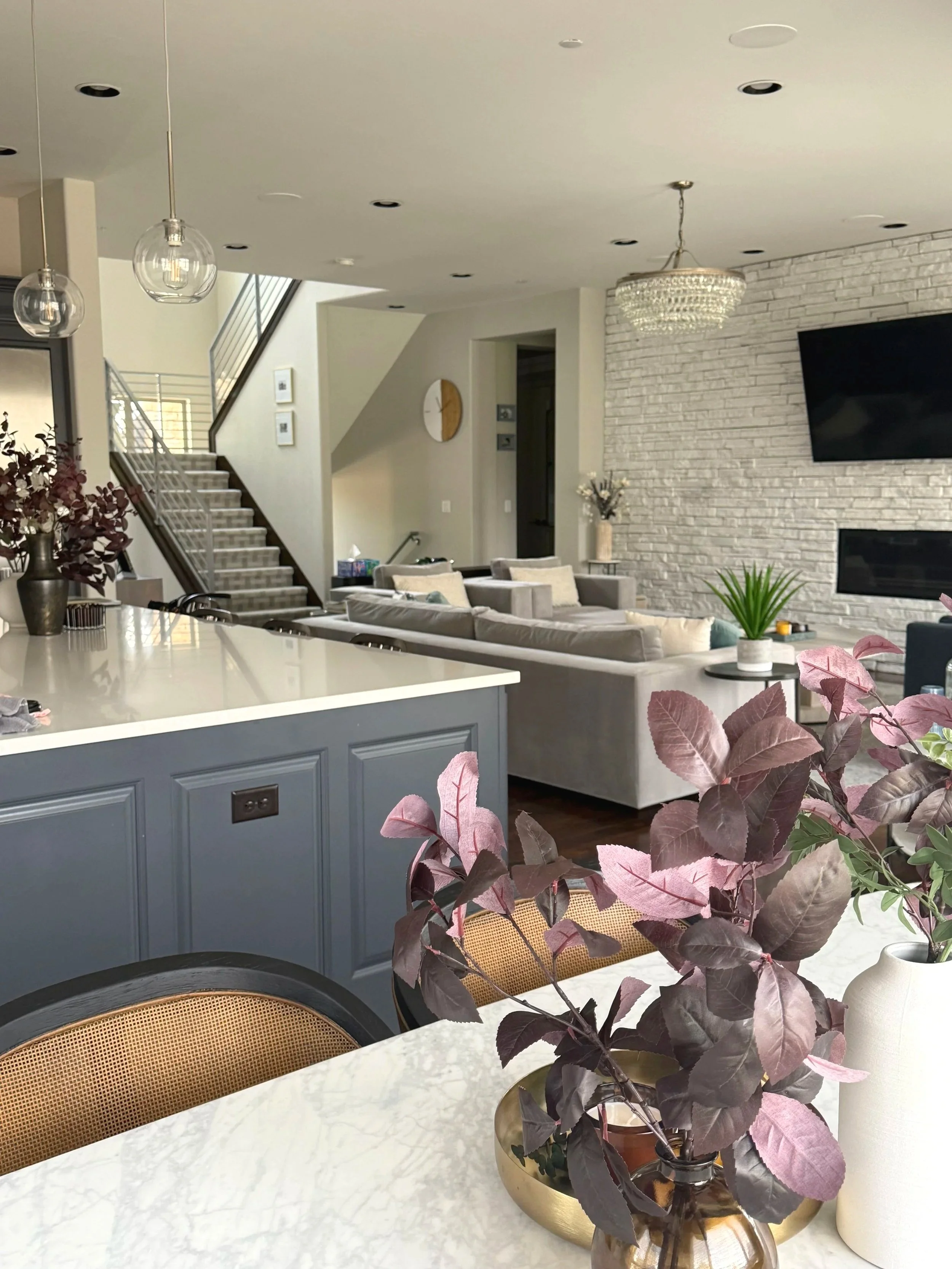 Haveli Designs based in Colorado. Open concept family room with Arhaus marble dining table, cyberspace painted island. Timeliness livable luxury that is family friendly.  South Asian residential Designer.