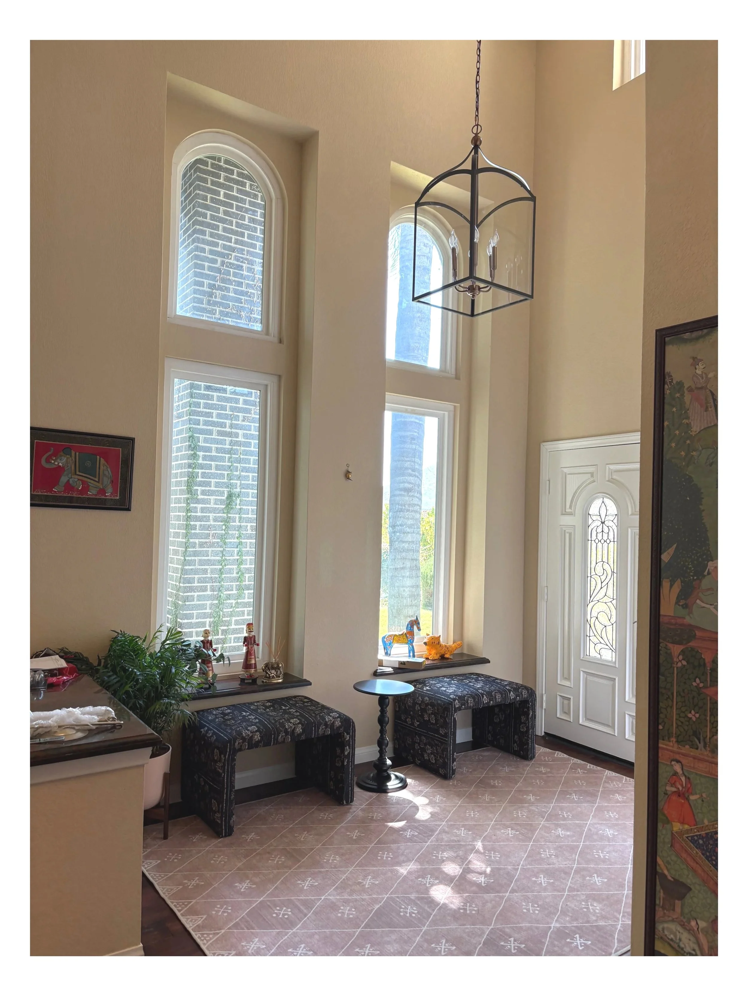 South Asian Formal Entry refresh with Ruggable Kavi Rug, Hinkley Jeremy Birdcage light, Arhaus benches and Finley cabinet. Design by Haveli Designs in Colorado. Features Mind The Gap wallpaper as murals and embossed trim. 