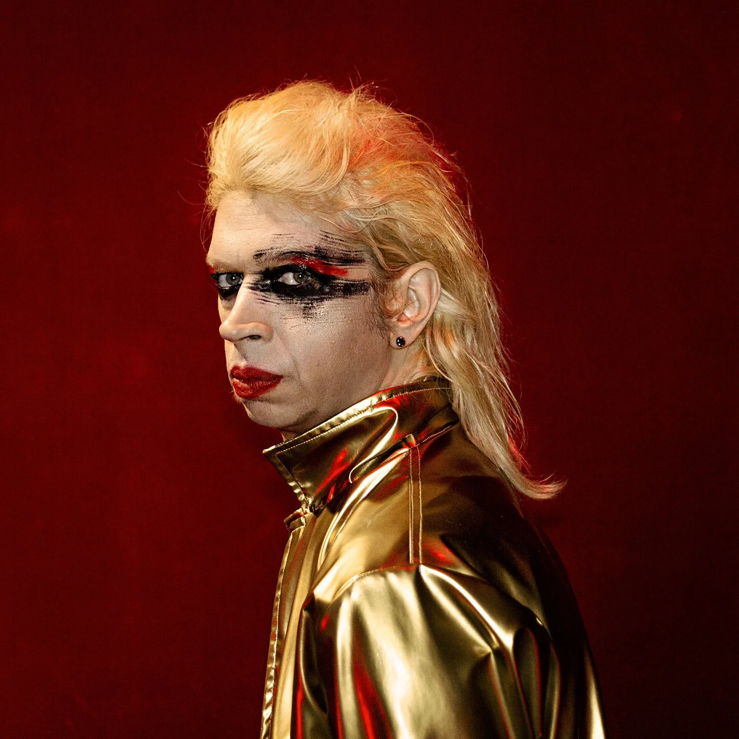 Band press photography for rock musician Slimmy with avant-garde make-up and golden jacket