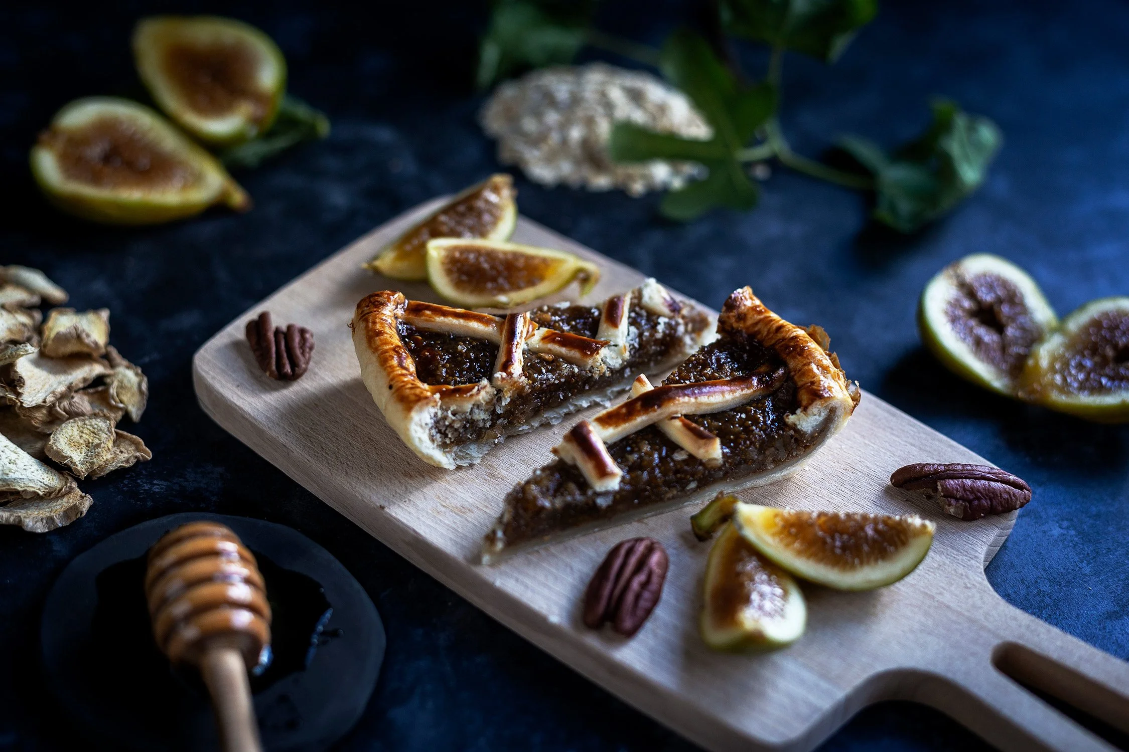 Moody food photography of a fig pie with honey and ginger