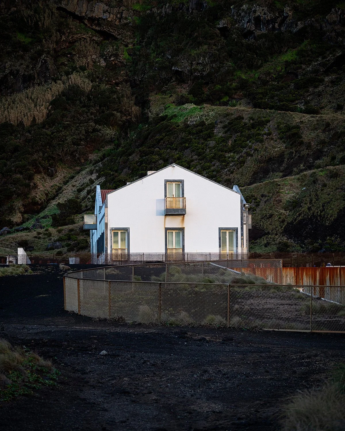 Beautiful landscape photography of white house in vulcanic soil area in Azores, A Porta do Diabo