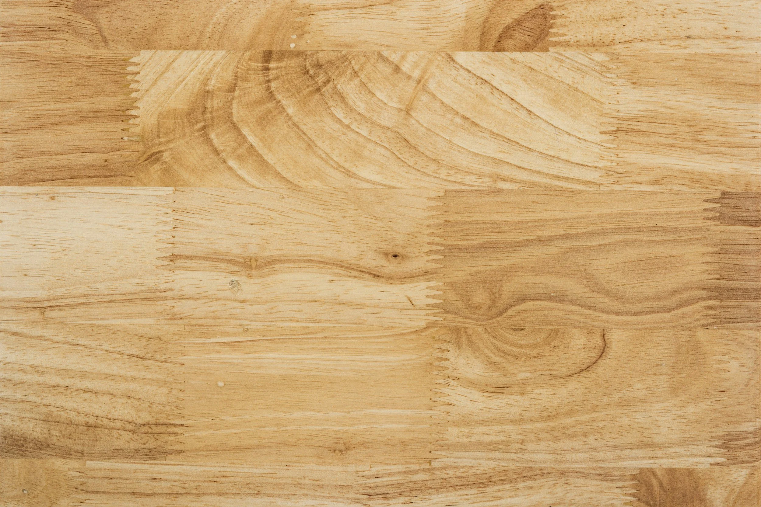 Wooden cutting board with round hole, resting on fabric.