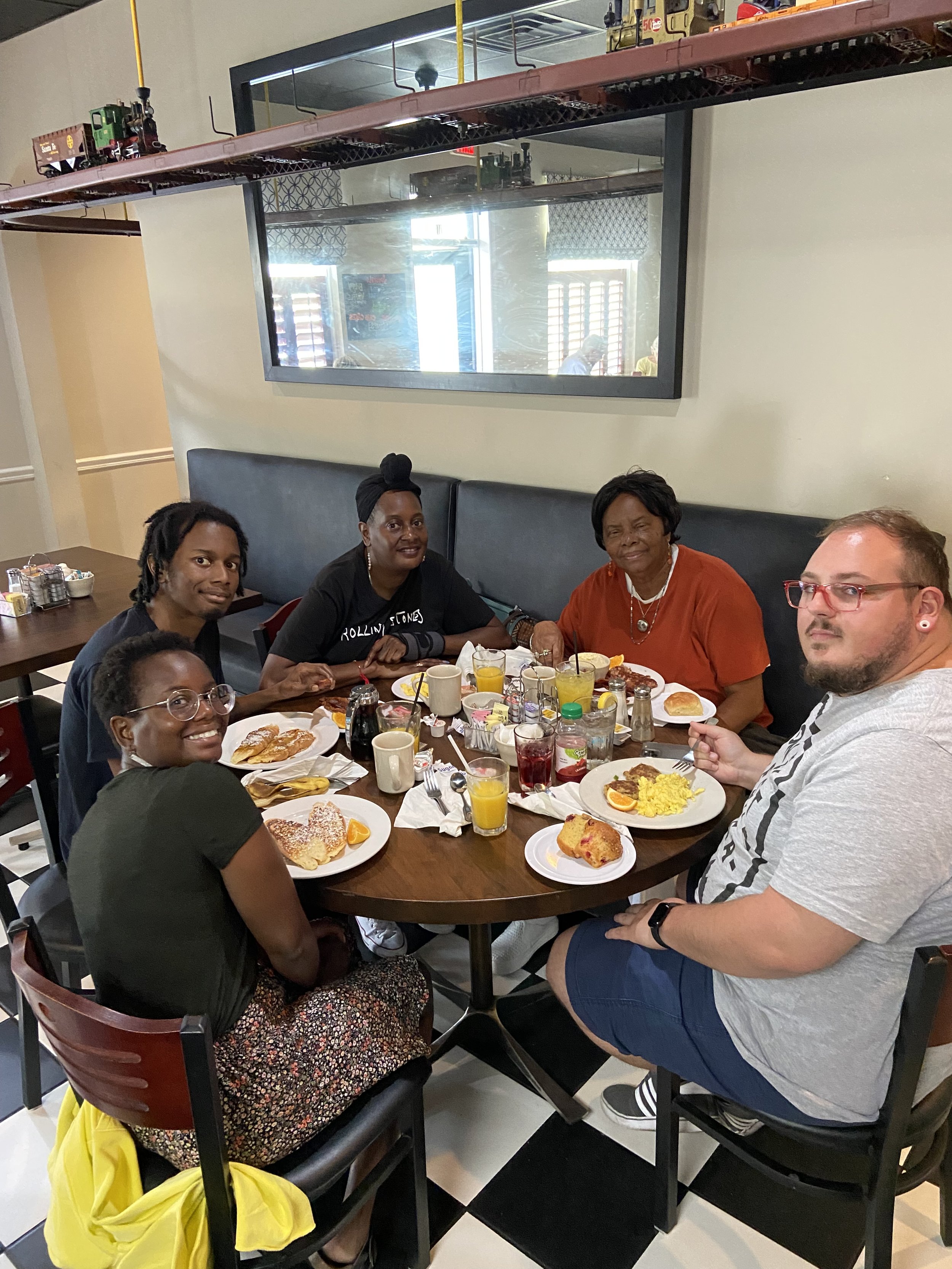 Group of people having a meal together at a restaurant table.