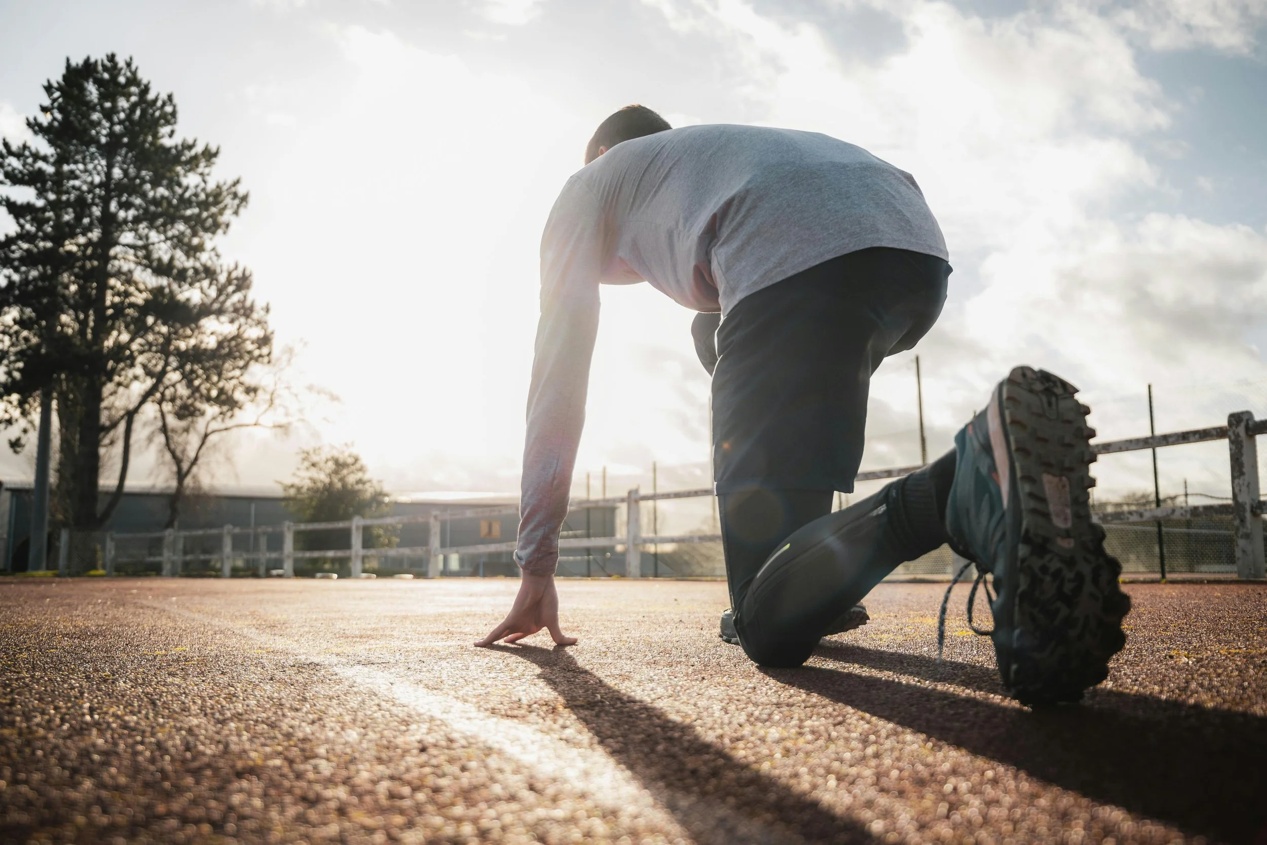 man on a track ready to run.