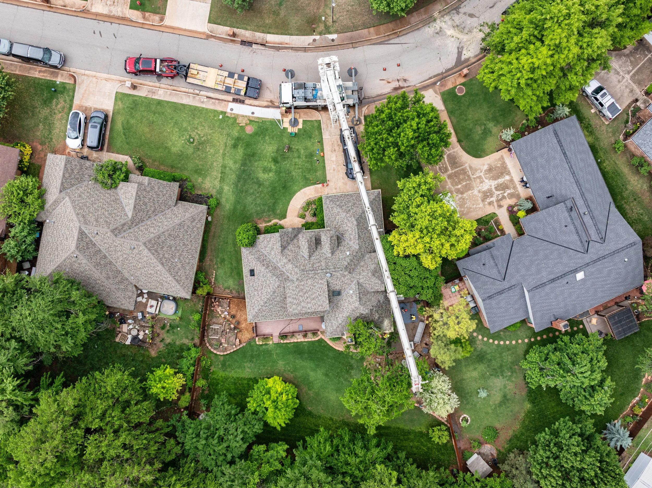 top down drone view of a tree removal using a crane in an Edmond neighborhood