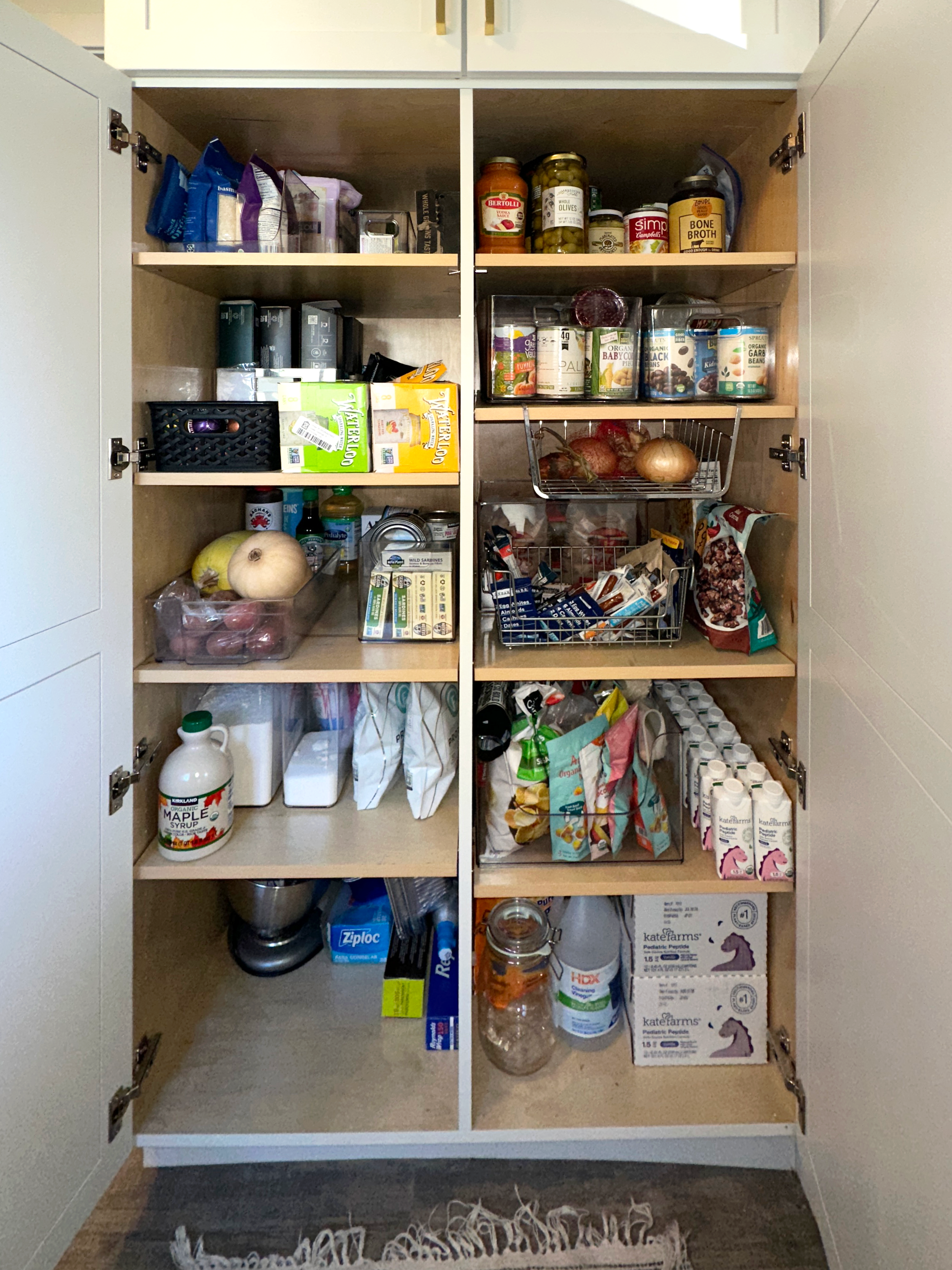 "After" of a professionally organized pantry in Denver, CO featuring categorized and organized food