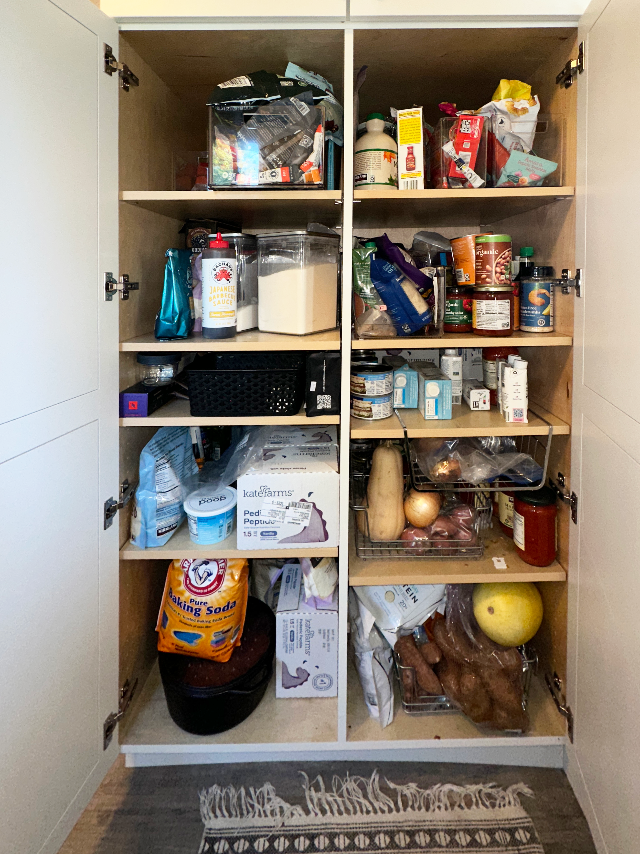 "Before" of a deep kitchen pantry with uncategorized and disorganized food