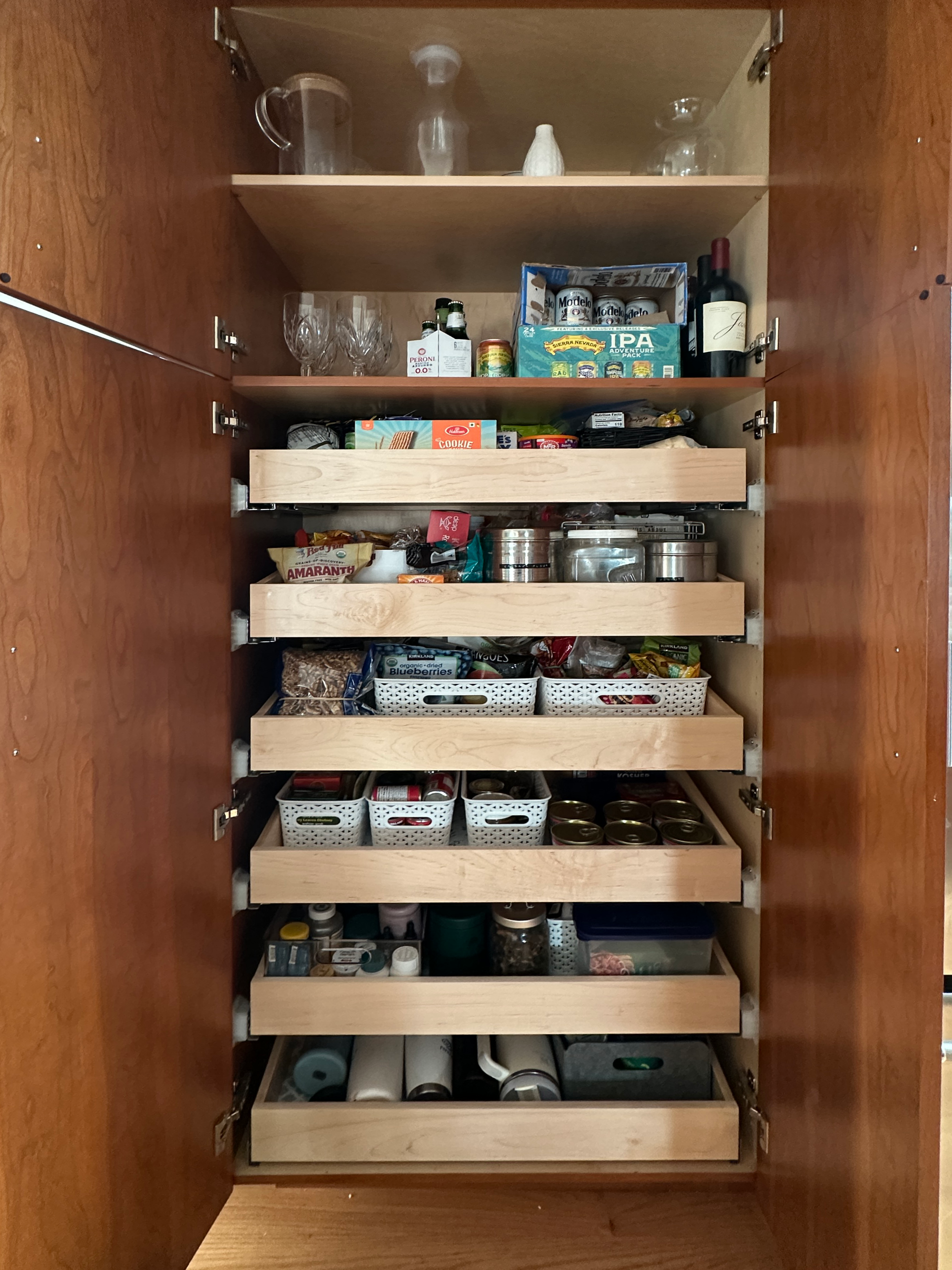 "After" of an organized and categorized pantry with bins and systems in place.