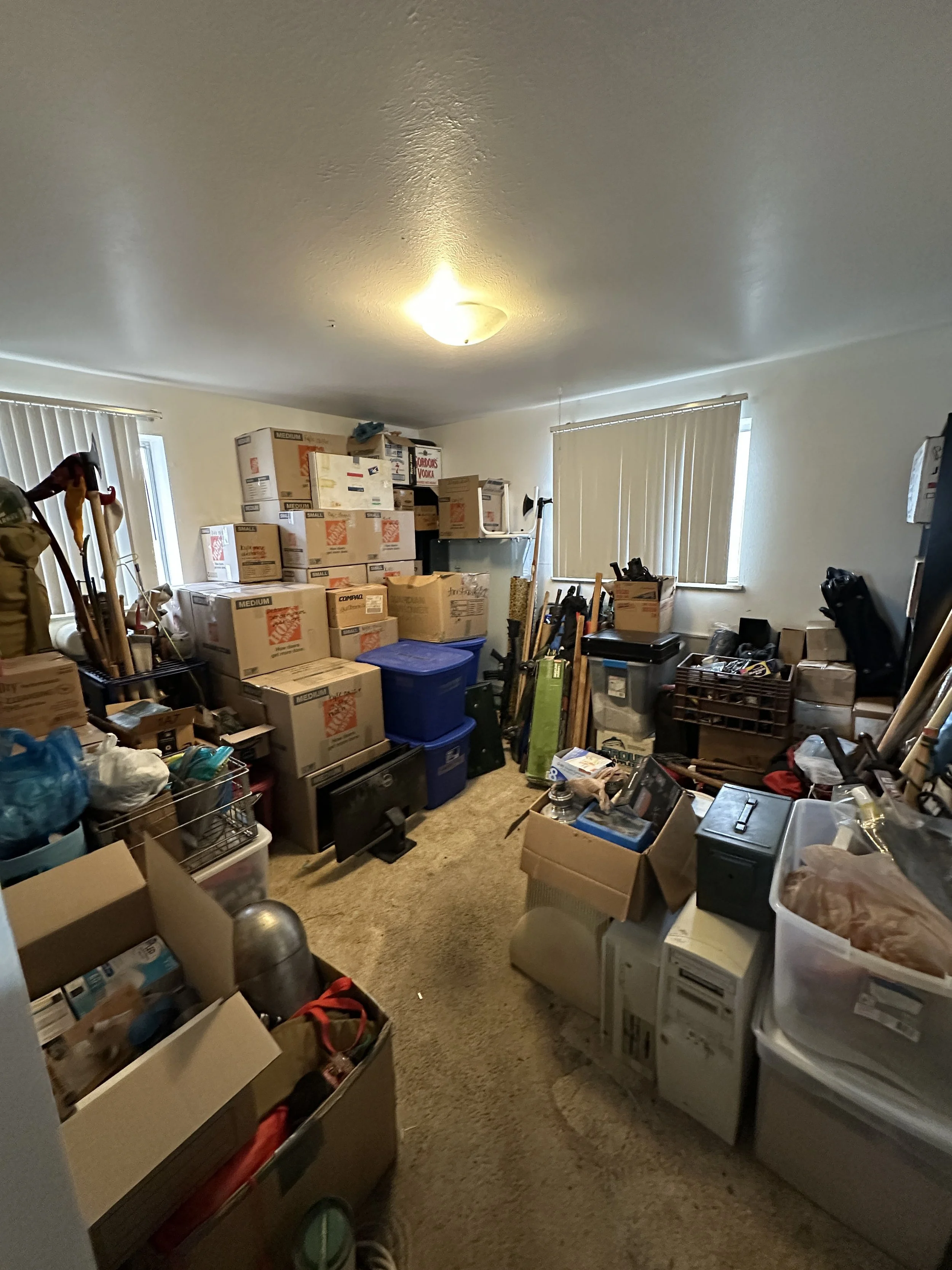After image of a spare bedroom that has been professionally organized, with nostalgic items cared for and sorted, belongings packed, and trash and donations removed from the home.