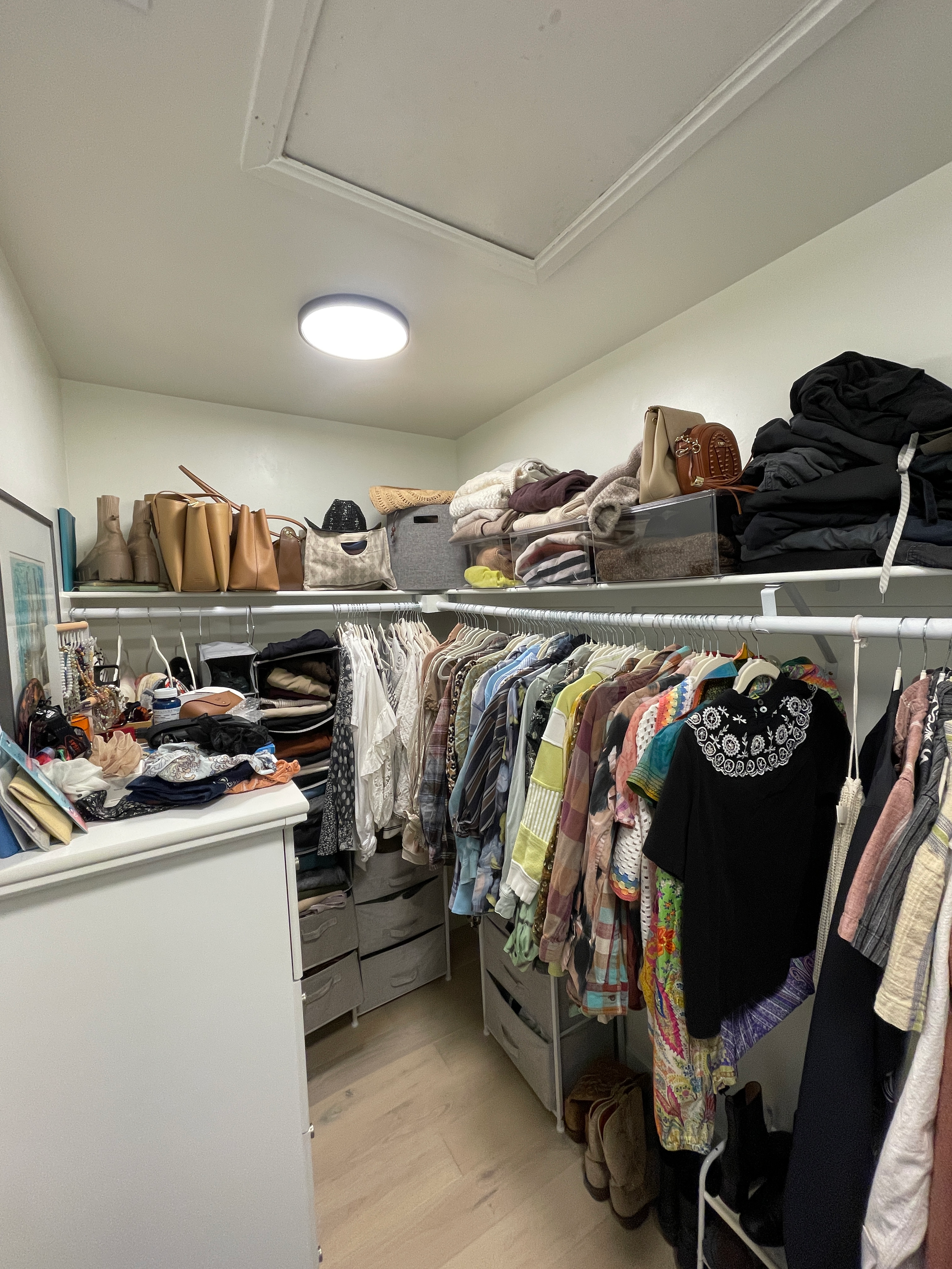 After image of an organized small walk in closet with clothing donations removed, clothing folded, organized by style and use, and prepared to review for packing and moving in Boulder, Colorado.