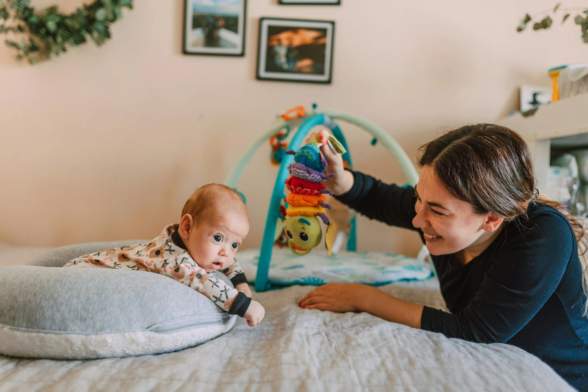 Baby doing tummy time supported by pillow