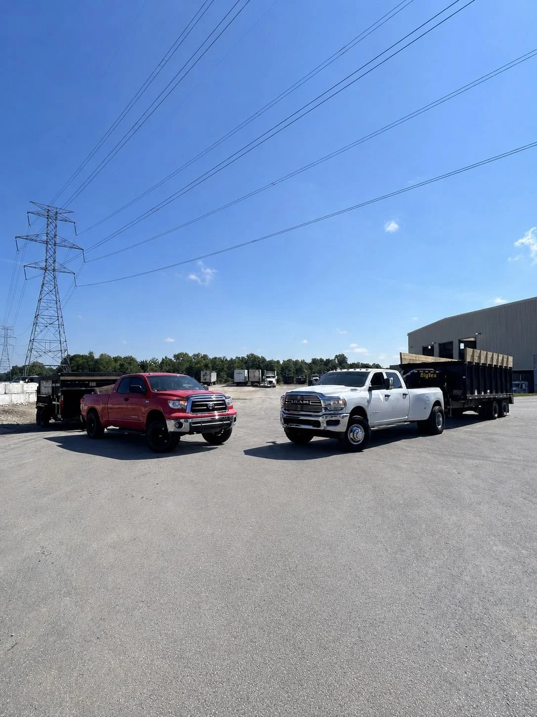 Latham Junk Removal equipment photo including a ram 3500 and toyota tundra and 2 large dump trailers.