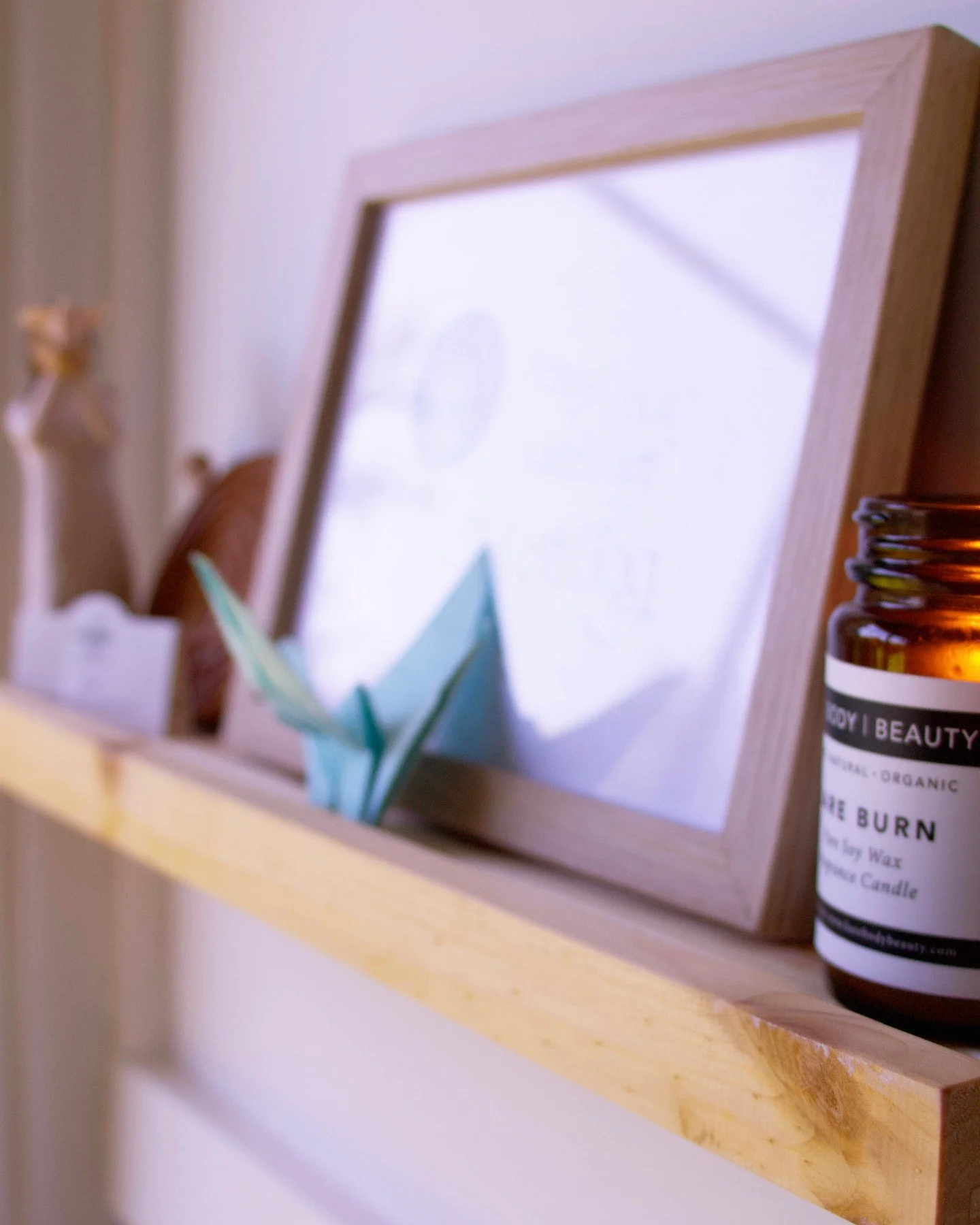 Work &bull; Space

This shelf sits behind my desk, often quietly noticed during sessions.

The candle draws the eye to the flame, a reminder of how things that seem separate are often deeply connected.

A blue origami bird, made by my son when I comp