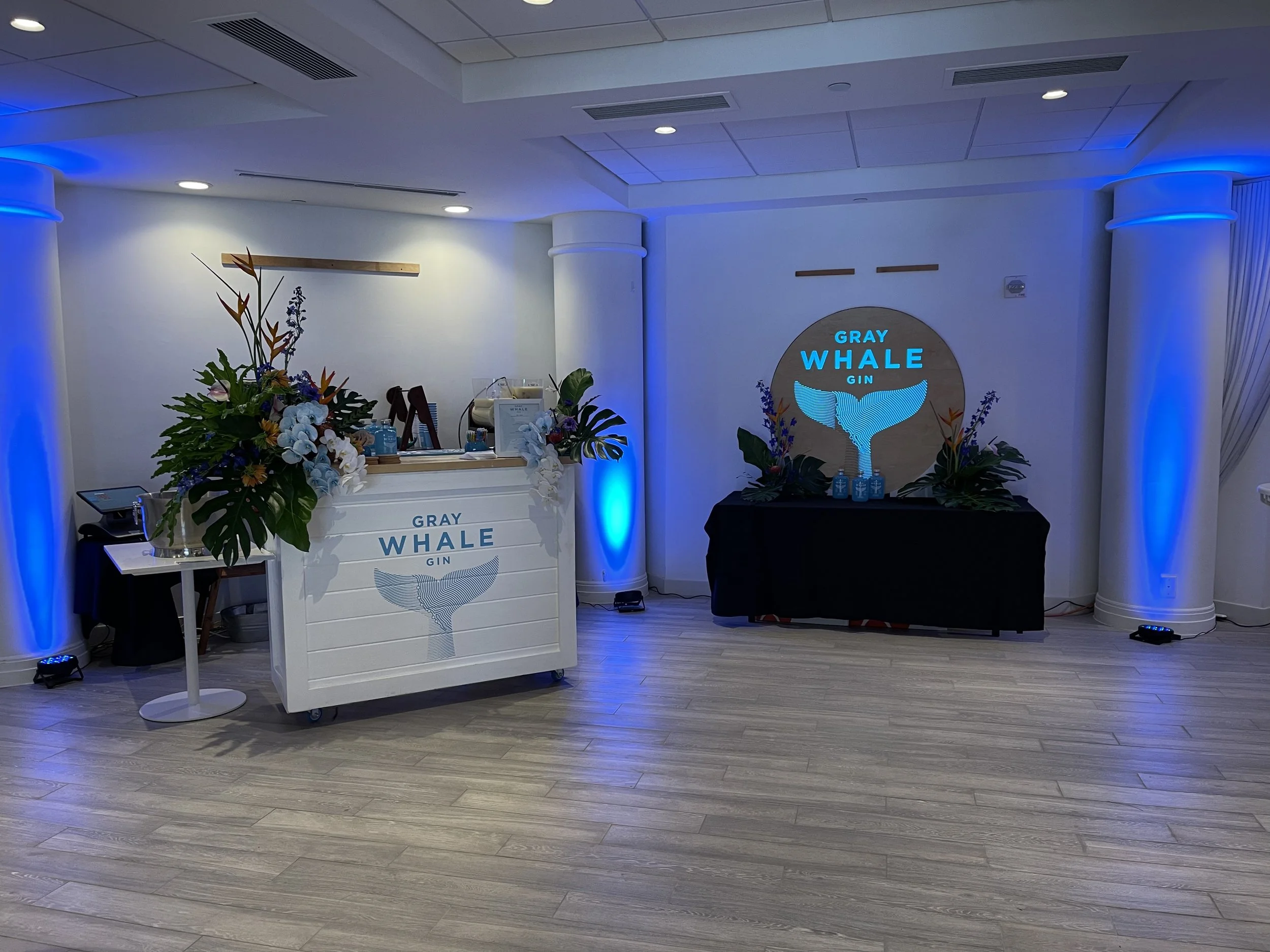 Experiential production Gray Whale Gin custom bar and backdrop sign LED backlit