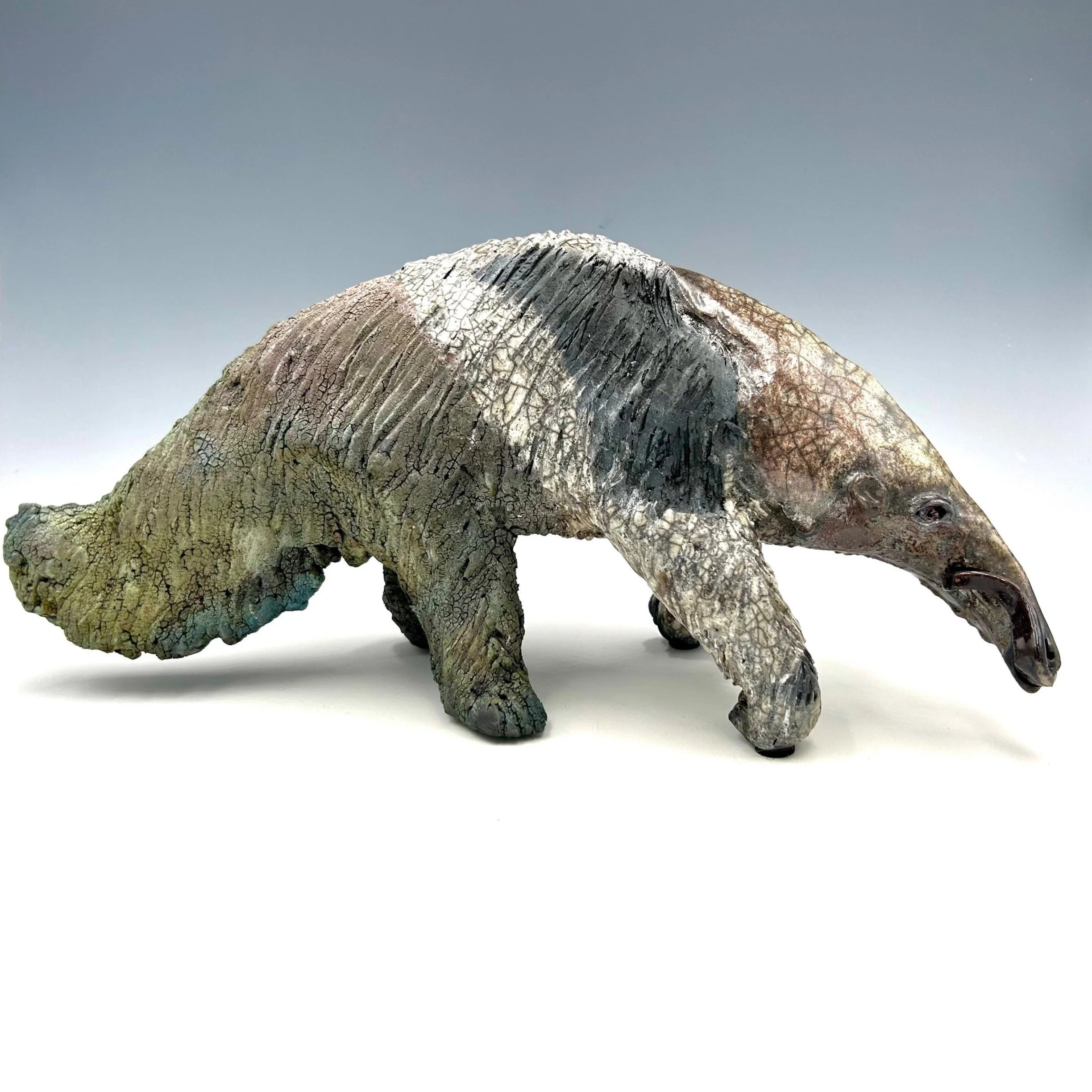 A ceramic sculpture of an anteater with a variety of glazes by Robin Henschel.