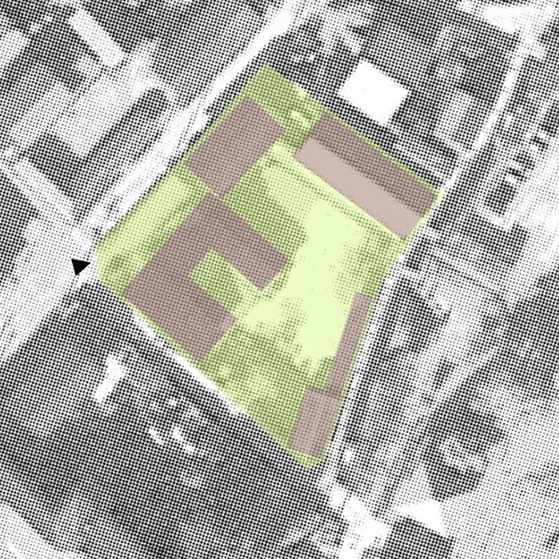 A black-and-white aerial map showing a rectangular sports field with surrounding buildings, parking lots, and nearby streets.