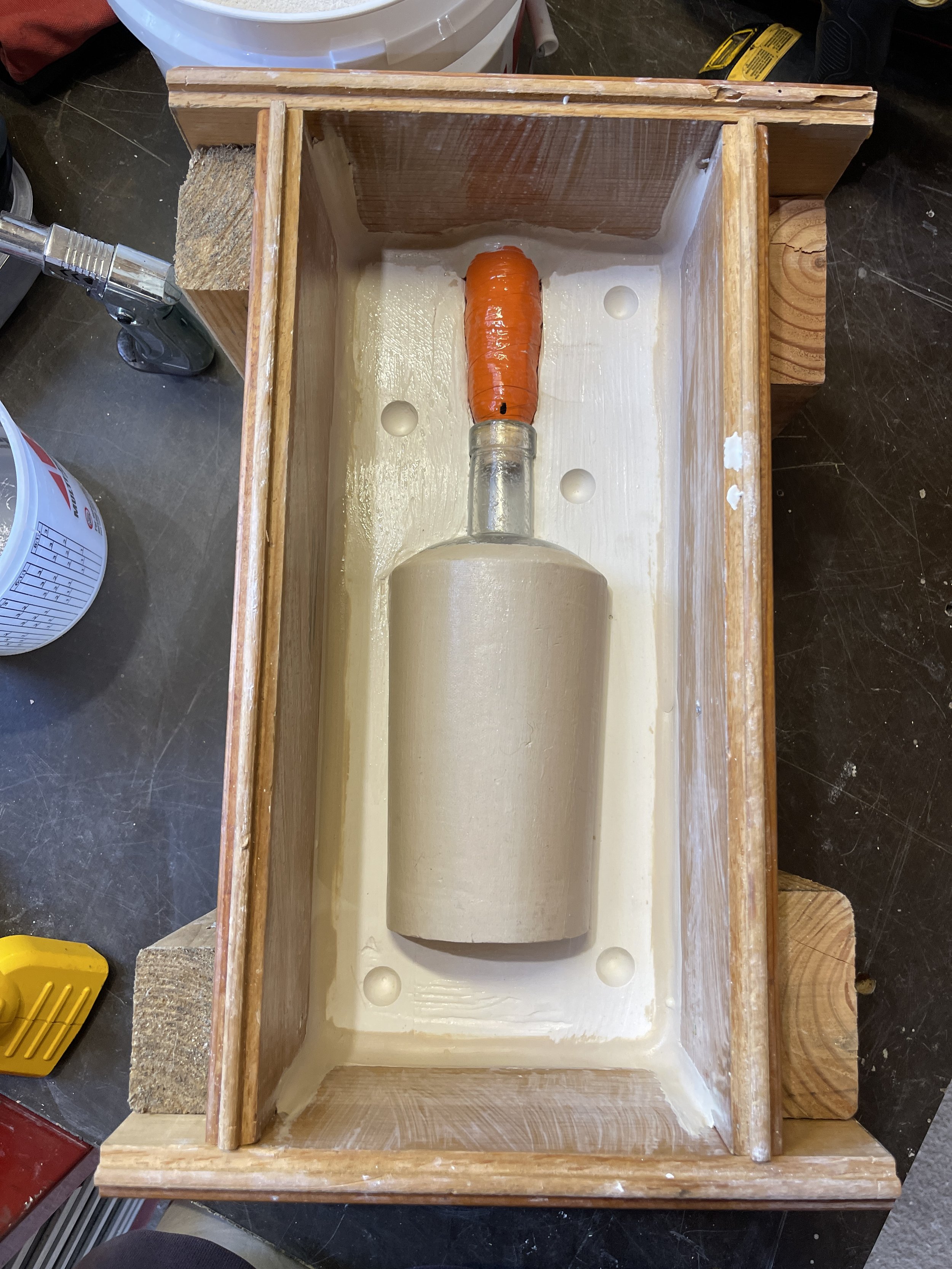Wooden mold with a bottle inside