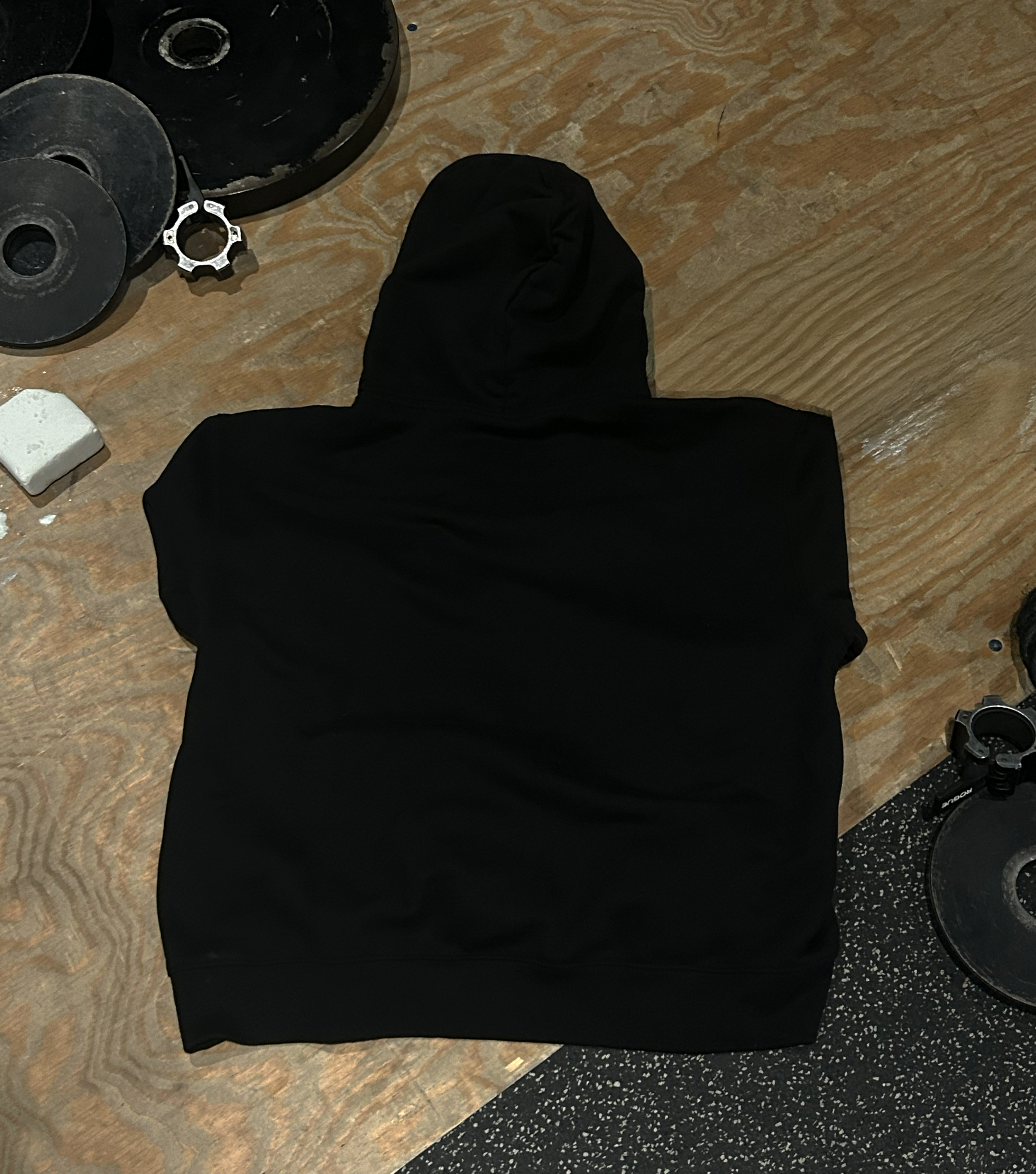 Hoodie-On-Ground-Black-Back-Final.png