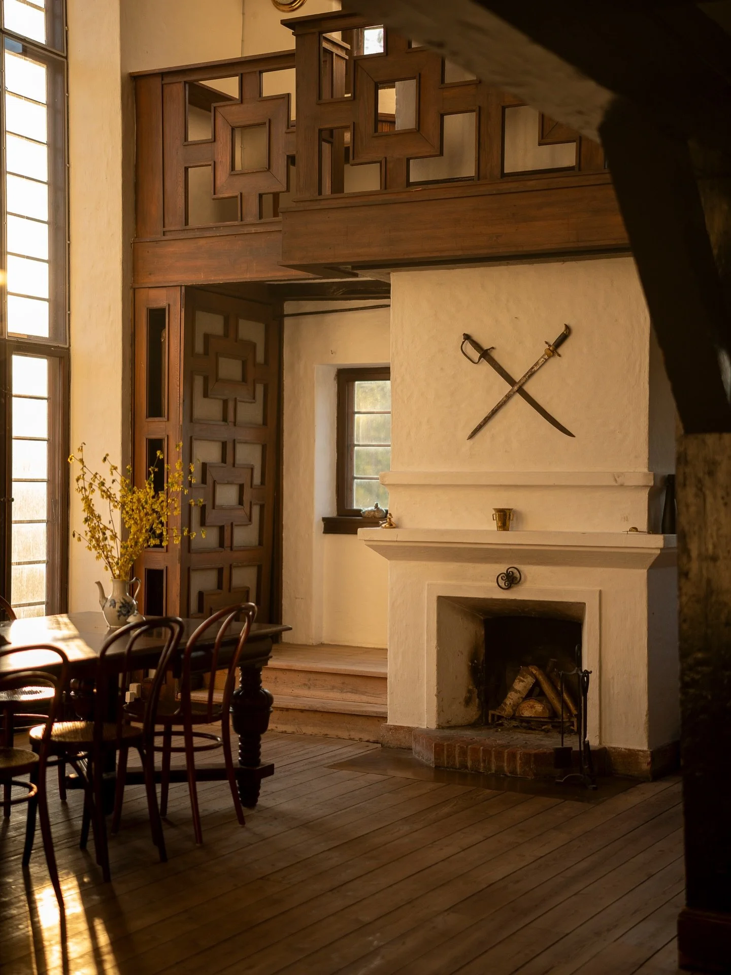 Crossed swords, candlelight and a long by the fireplace.
Not your average dining room.