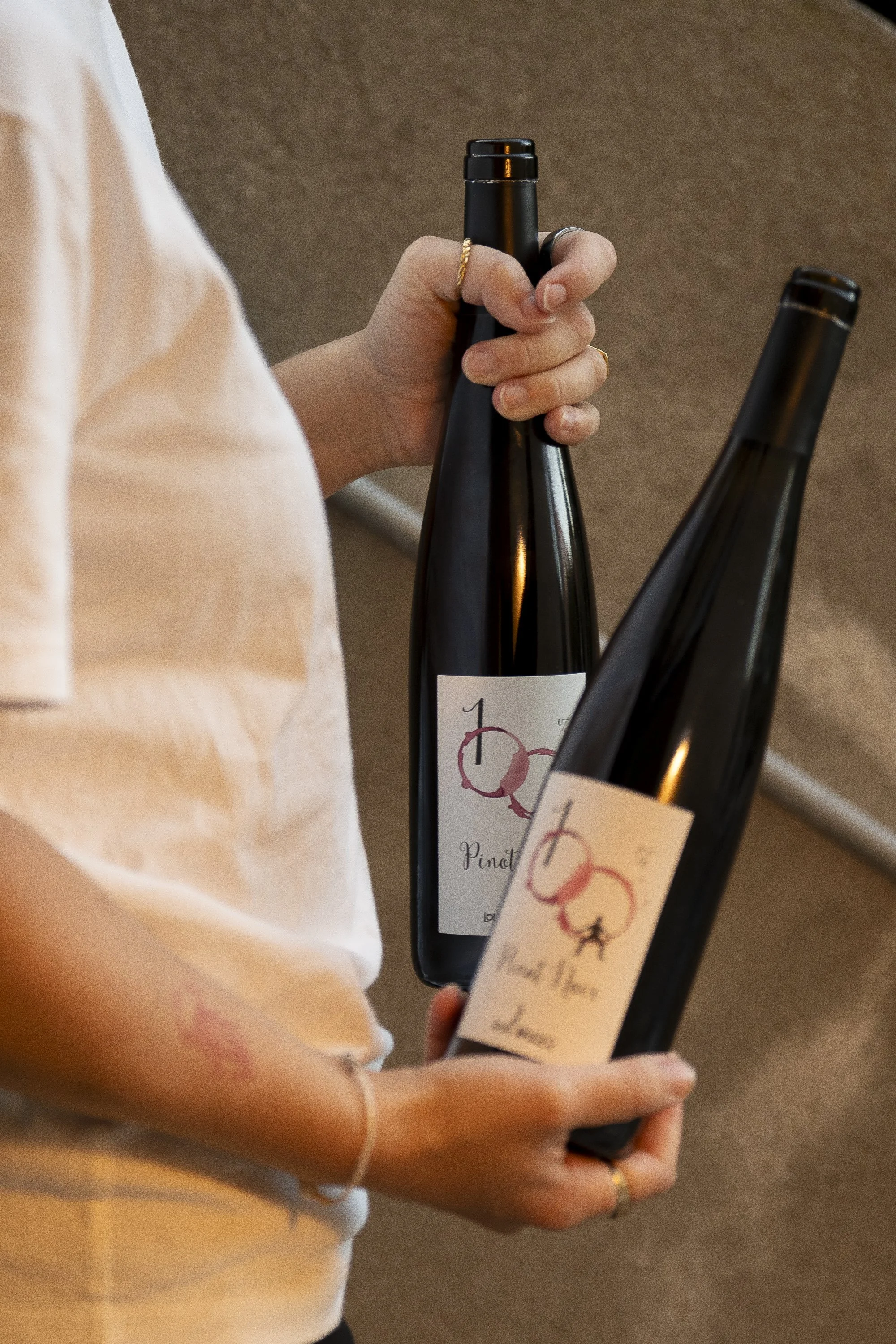 A host opening a bottle of handpicked wine for an intimate wine tasting experience in the historic cellar.