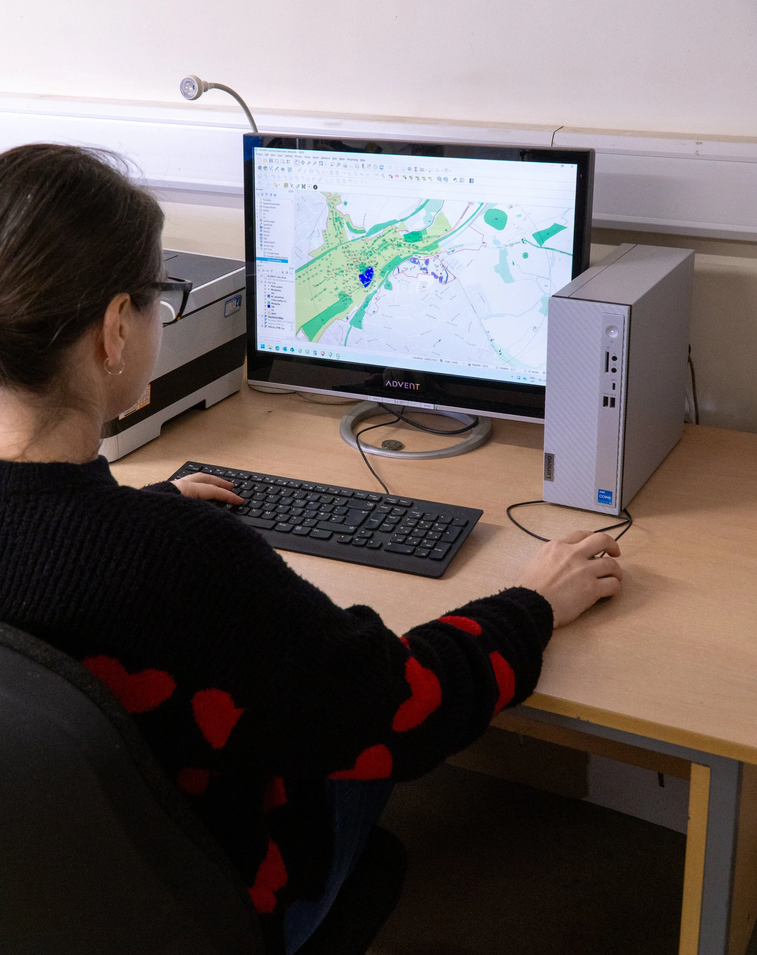 Historical map of Exeter, showing streets, parks, and landmarks, with illustrations of notable buildings around the border.