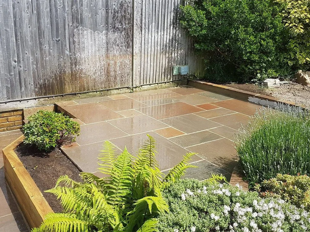 different coloured garden paving with boarded garden with ferns and other greenery