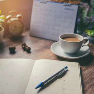 Desk with a planner and calendar, representing planning for 2027 ACA Open Enrollment