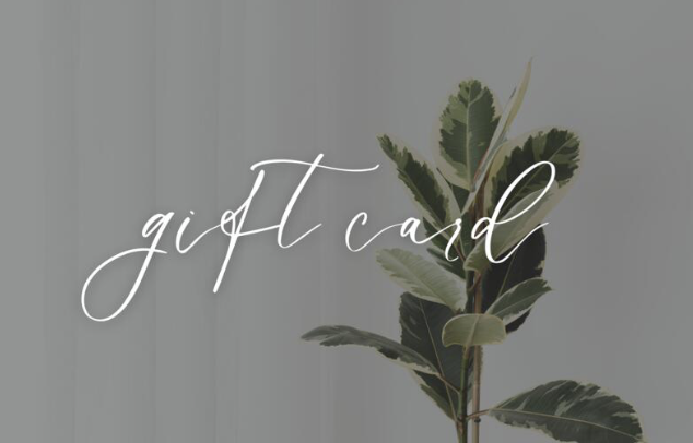 A gift card with elegant cursive text and a branch with green leaves in the background.