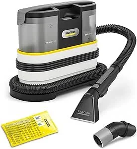Modern canister vacuum cleaner with a flexible hose and attachment accessories, including a yellow dust bag and additional nozzle.