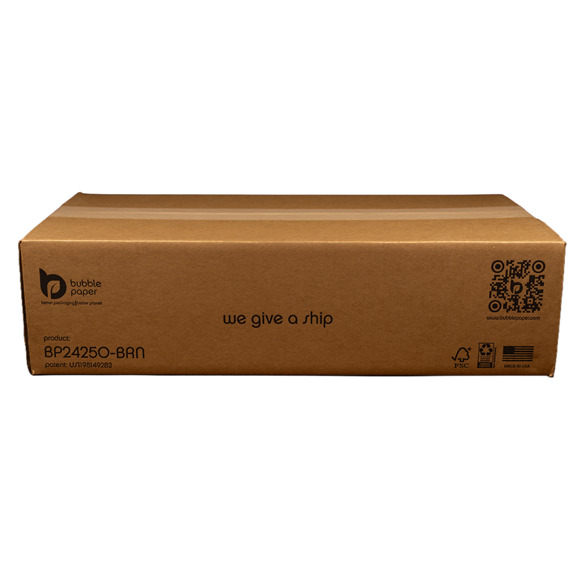 A cardboard box with the phrase "we give a ship" printed on it, along with sustainability credentials and a QR code, sitting against a black background.