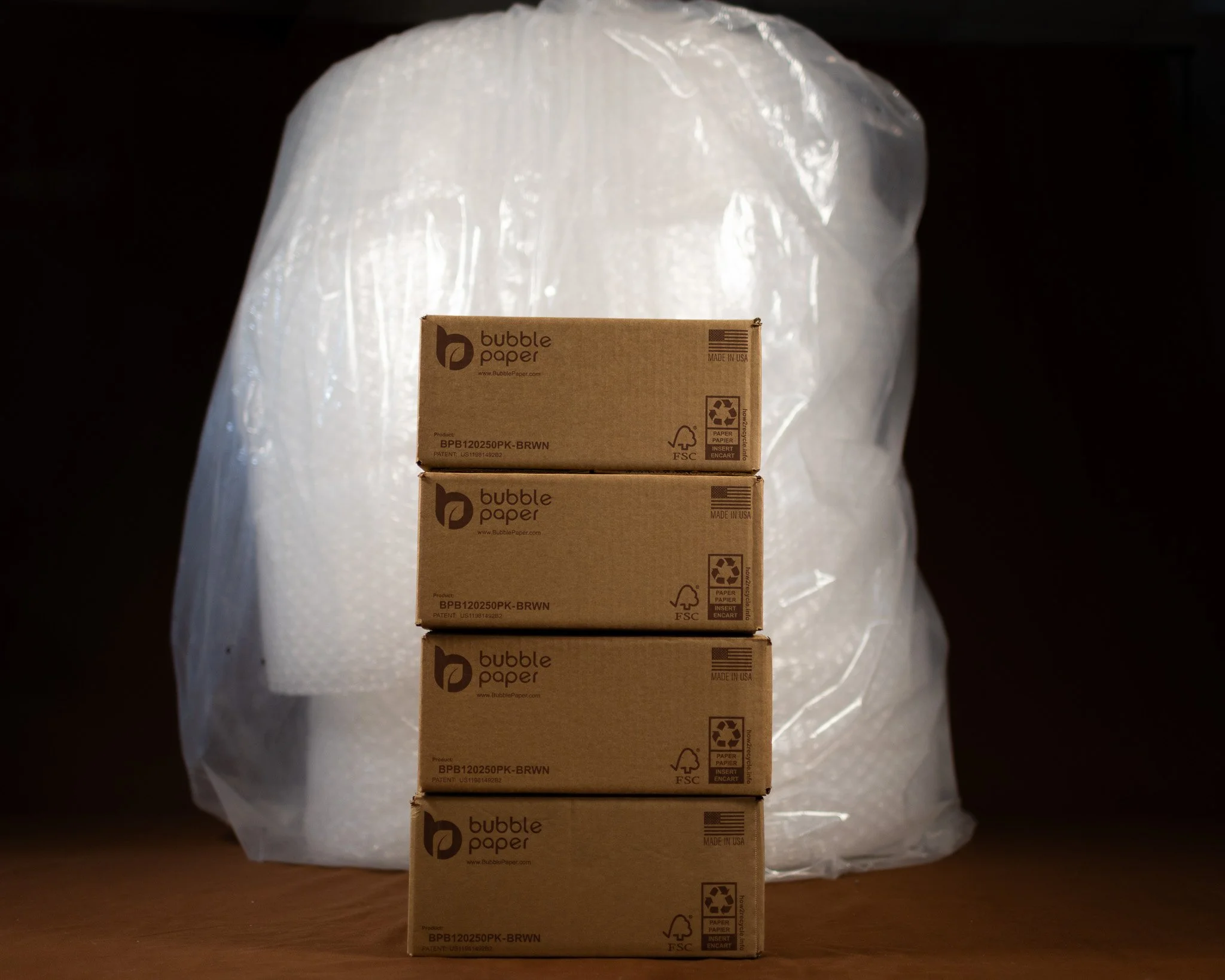 giant stack of bubble paper wrap and four small boxes of bubble paper wrap an eco-friendly alternative to plastic that is more compact