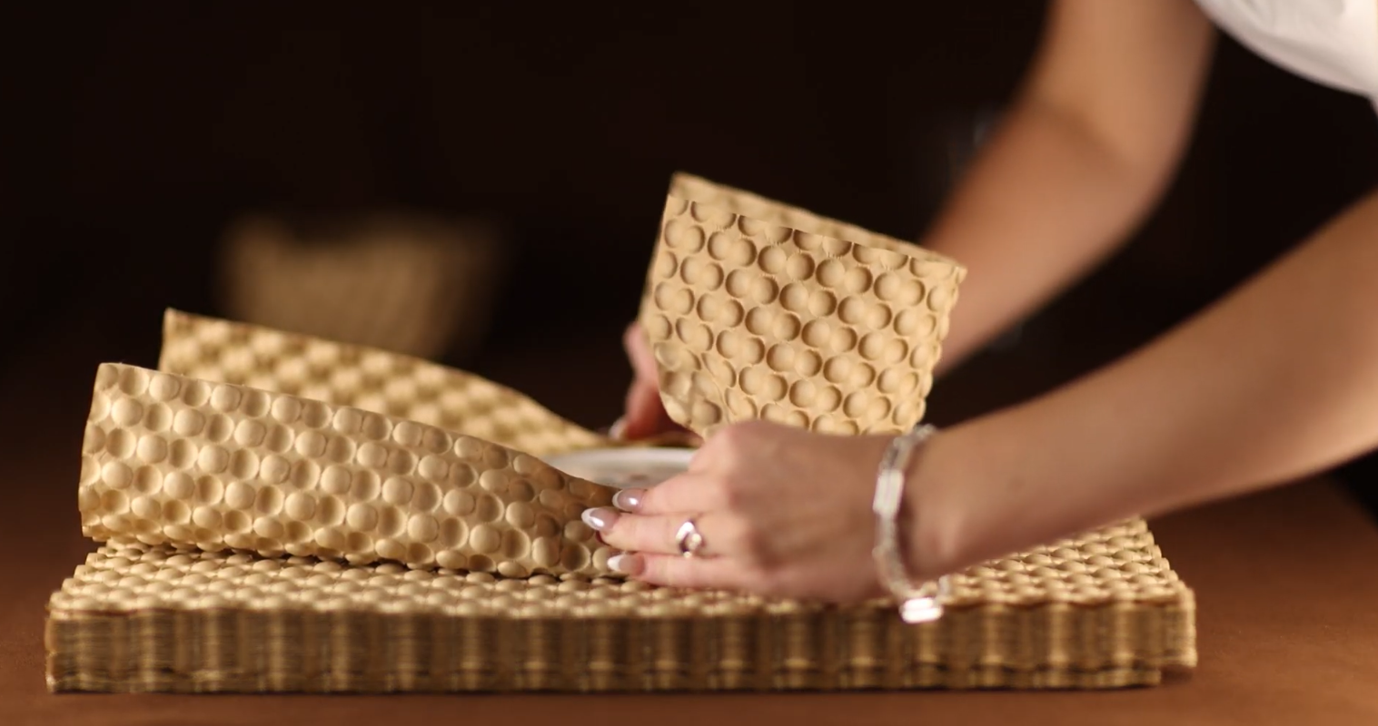 wrapping a plate using bubble paper wrap and showing how easy and efficient it is