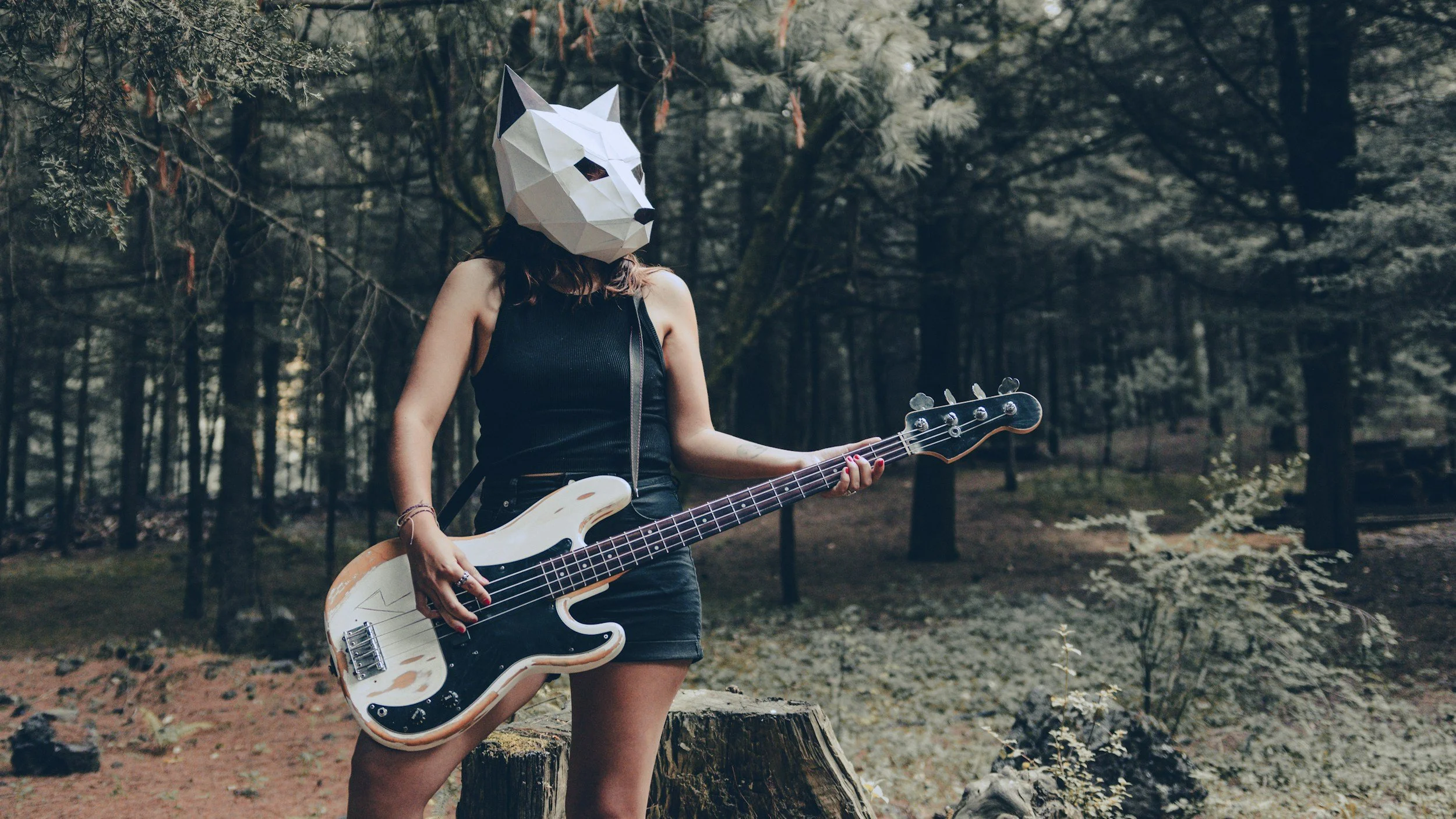 Street musician in a horse mask playing drums