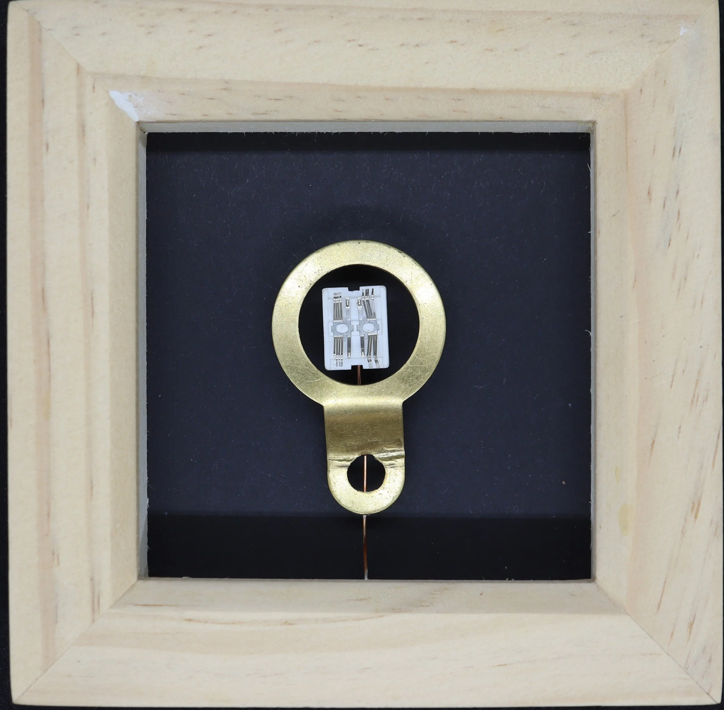 Close-up of a light switch socket inside a wooden frame, with the switch cover removed to reveal the electrical wiring.