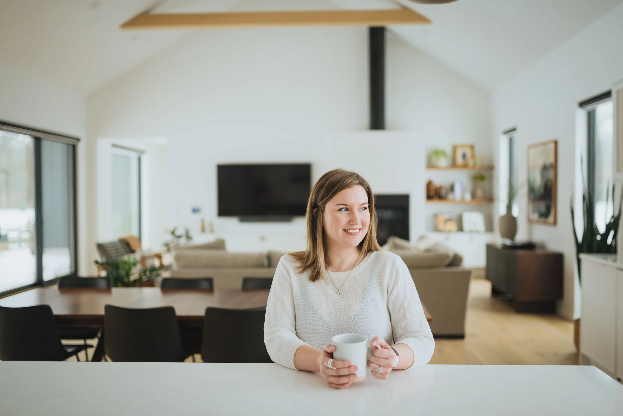 Realtor smiling while looking to her left.